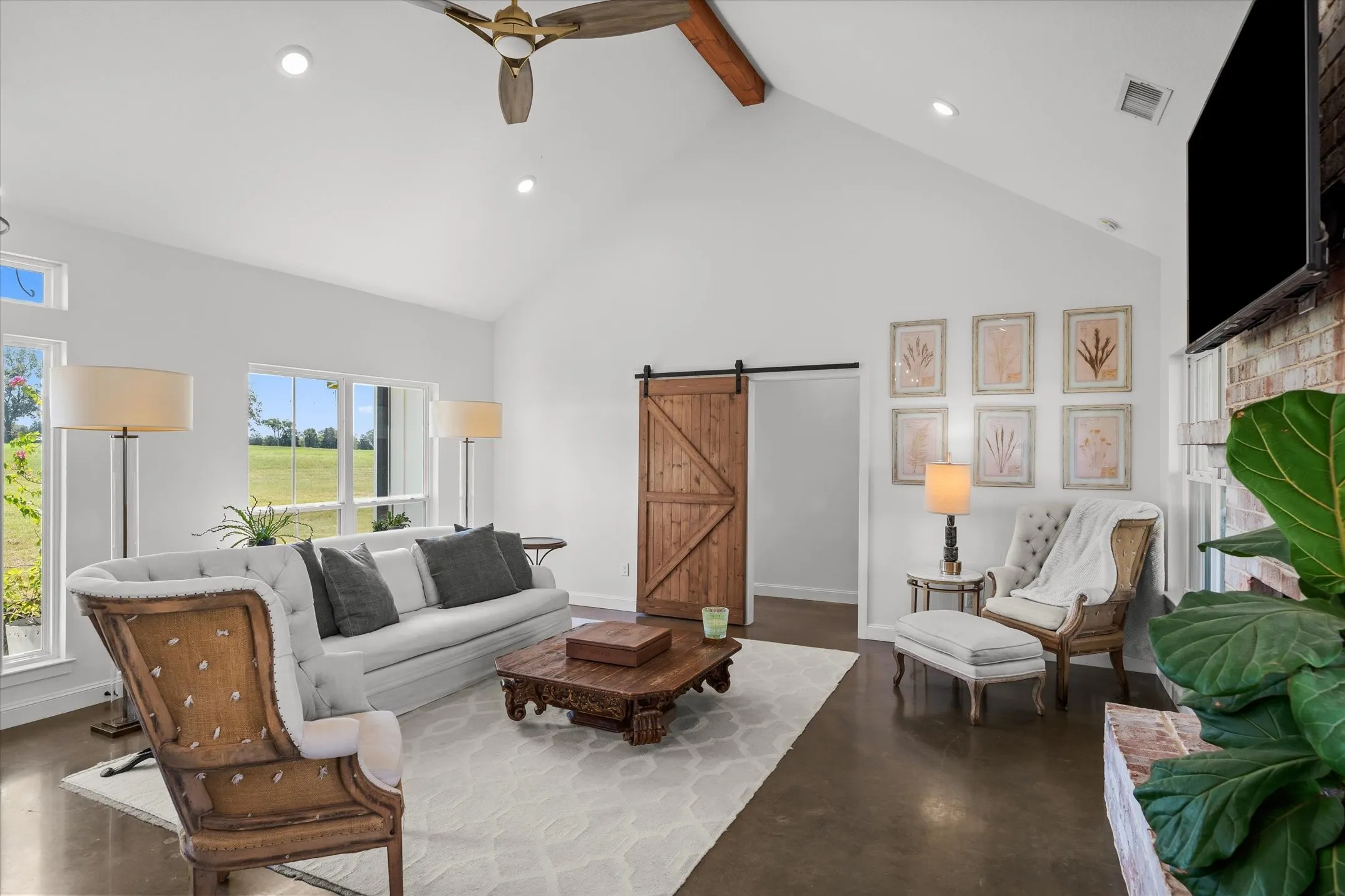 Vaulted ceiling with exposed wood beam, recessed lighting, and wood-finish ceiling fan