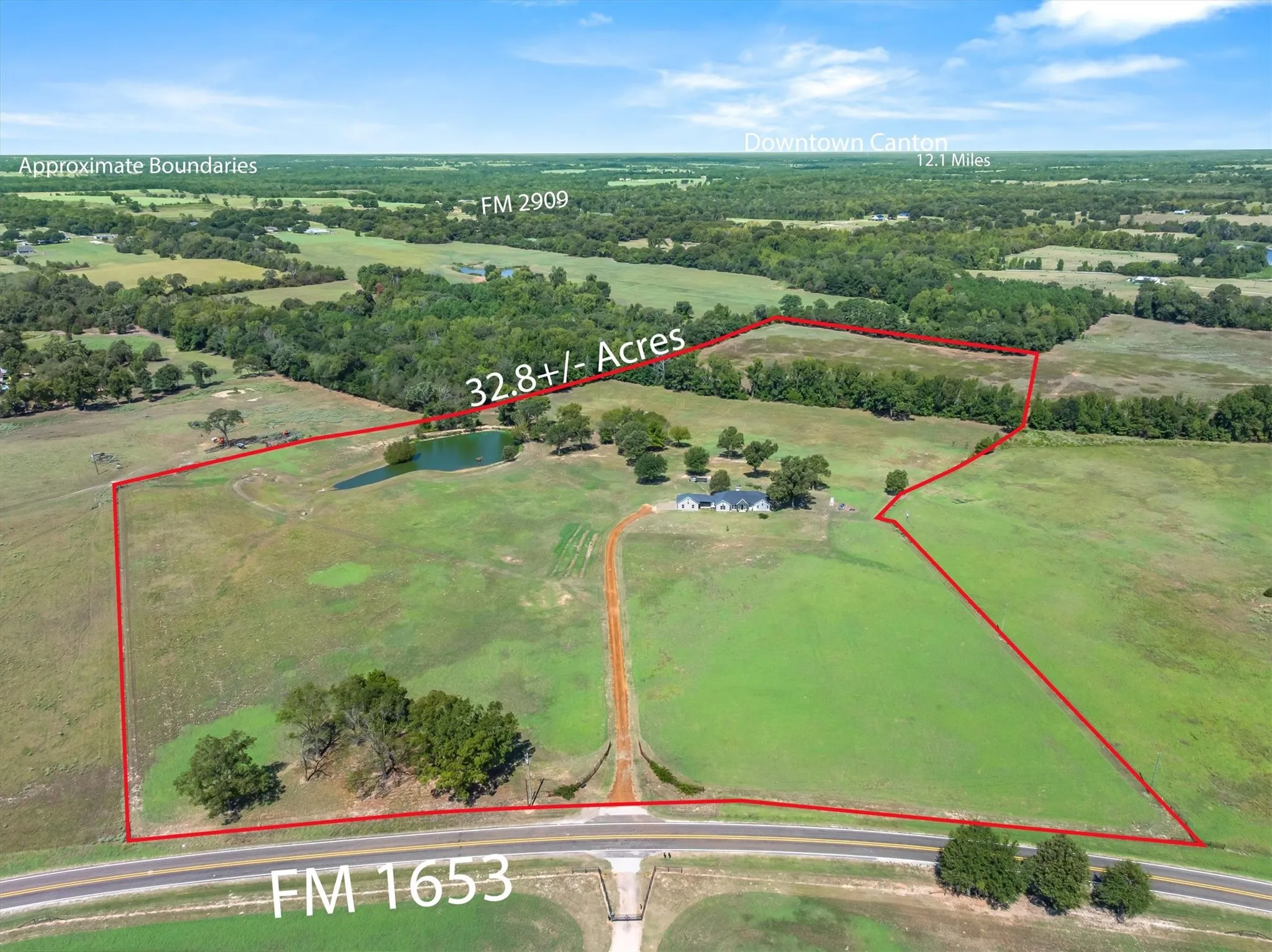 Expansive 32.8+/- acre parcel featuring a private pond, established treelines, and a detached residential structure