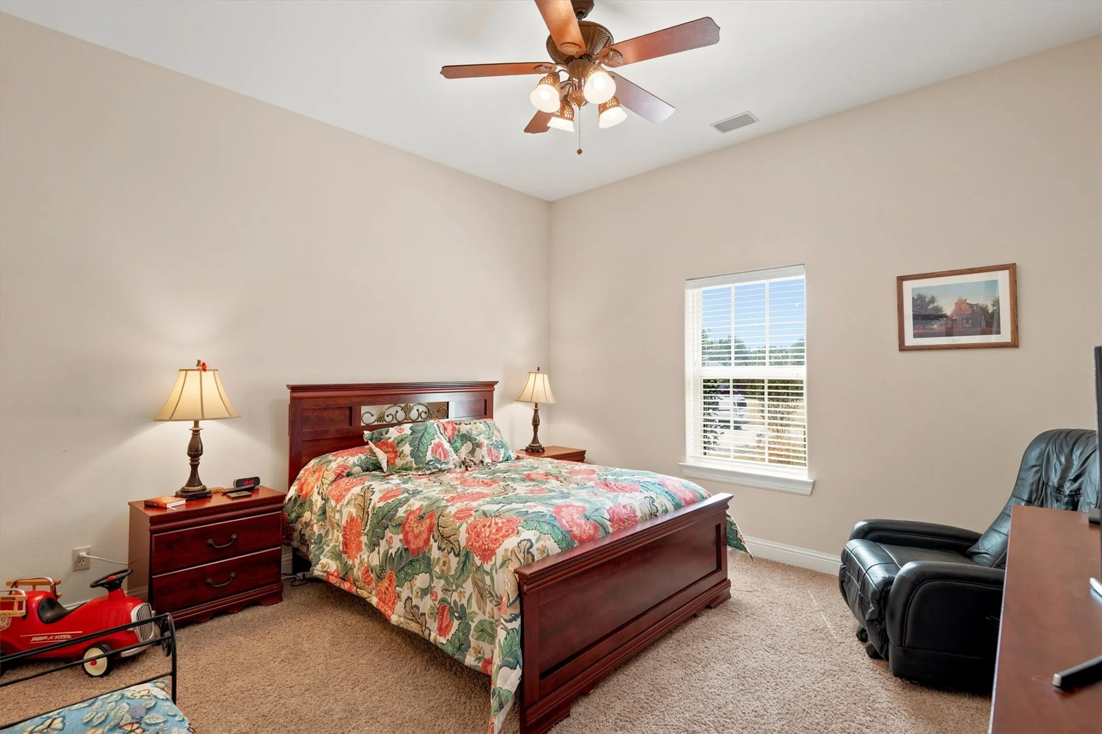 Vaulted ceiling with a ceiling fan, window with blinds, and carpeted flooring