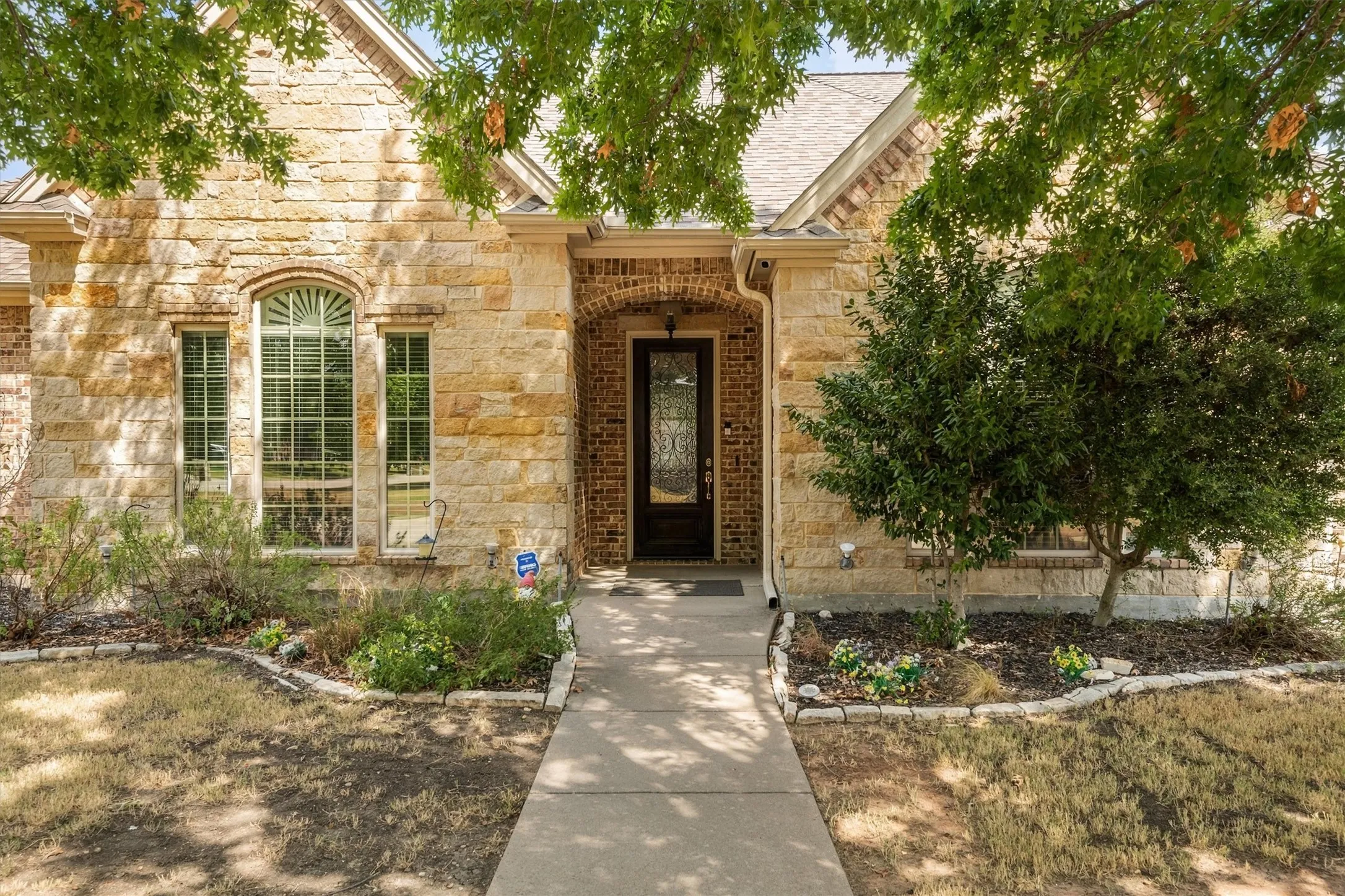 Stone and brick exterior with a gabled roofline