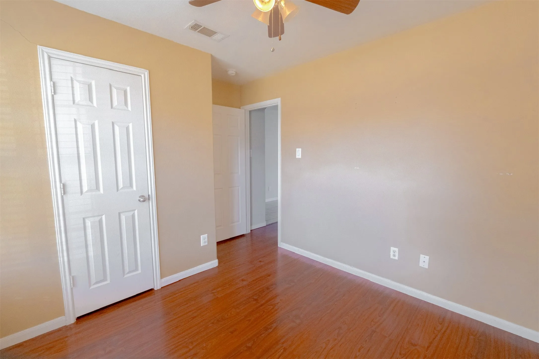 Unfurnished bedroom with light wood finished floors and a ceiling fan