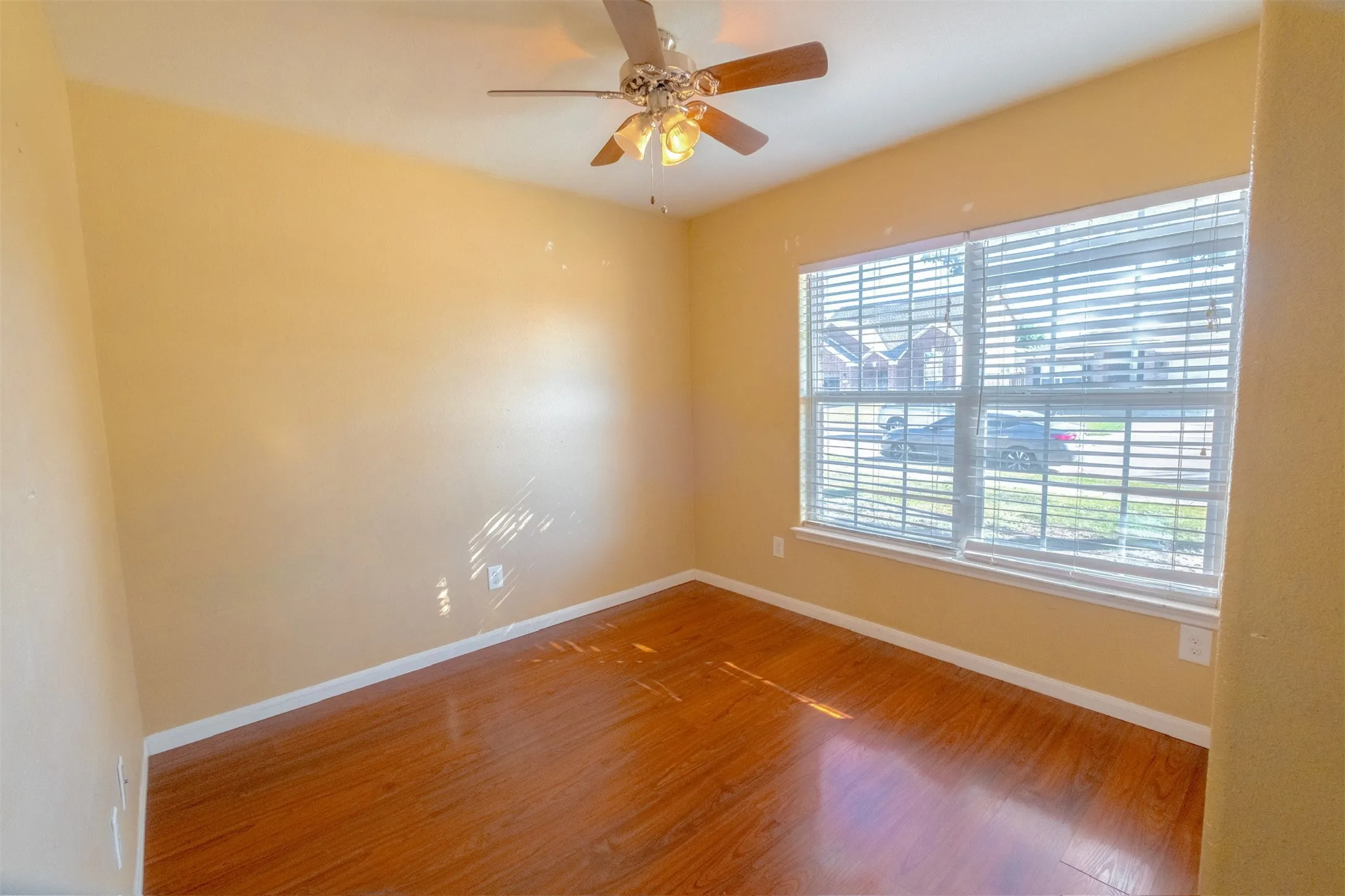 Spare room featuring wood finished floors and a ceiling fan