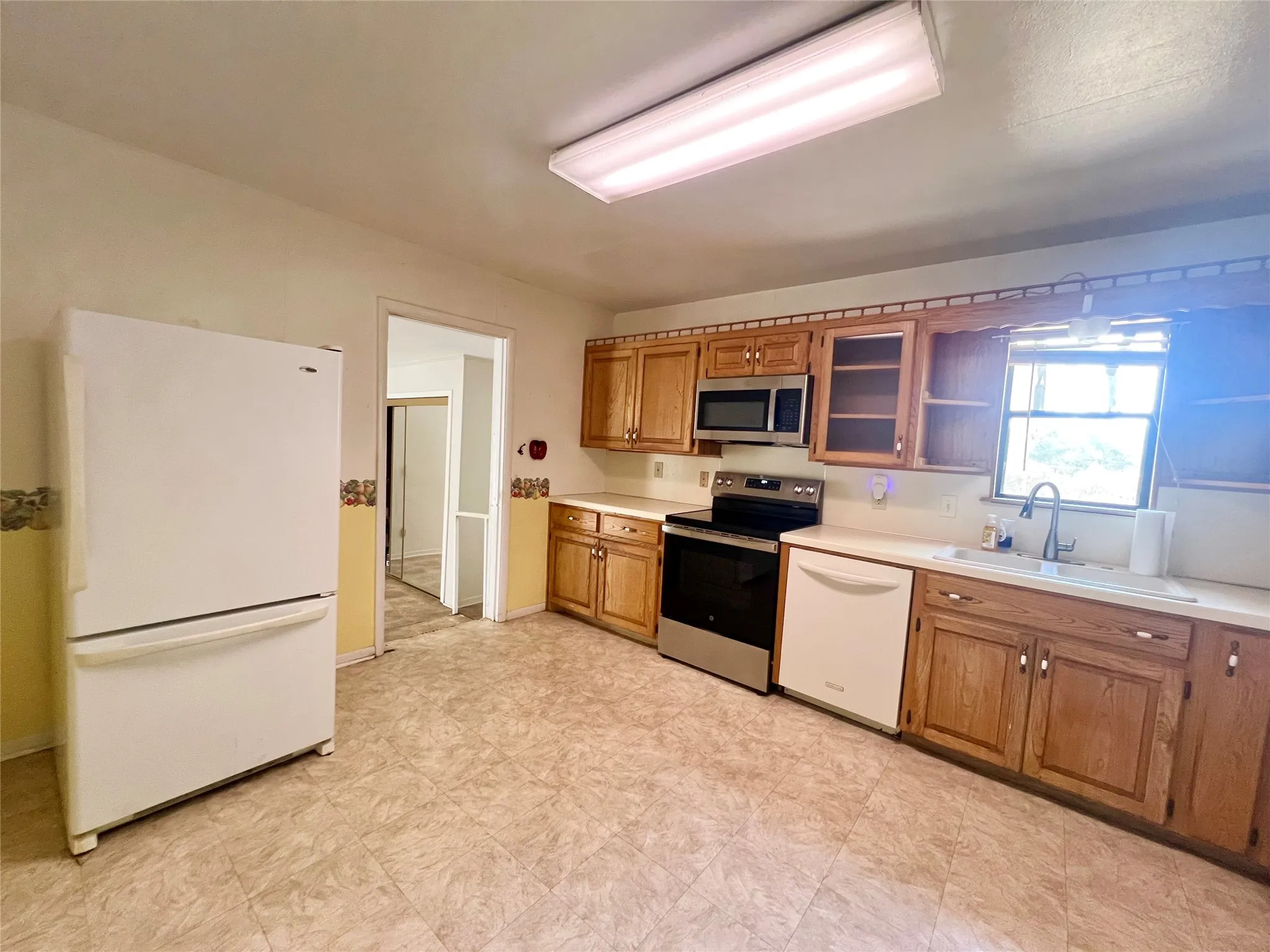 Updated stove, microwave, and kitchen faucet.