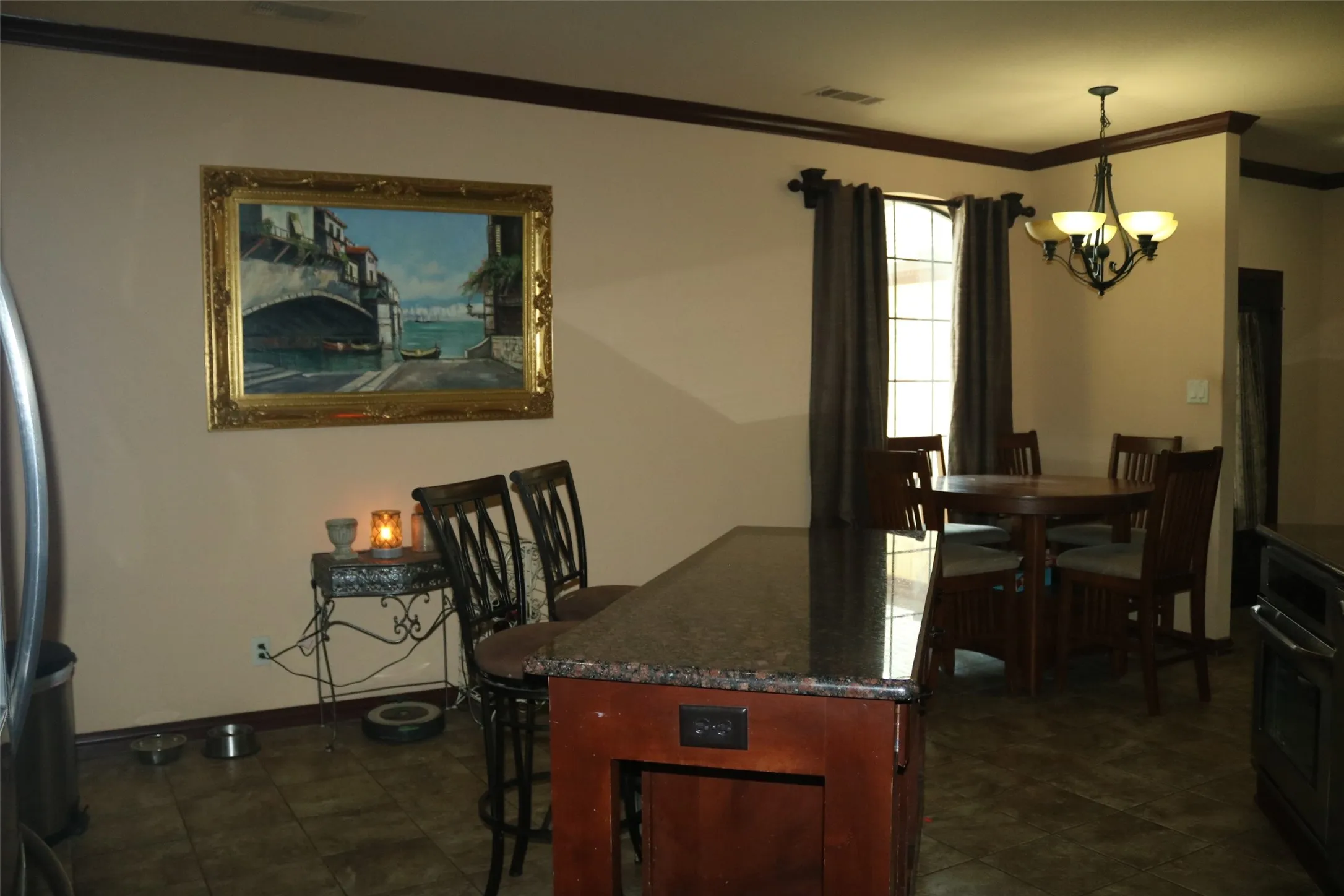 Kitchen island with a dark countertop and power outlet