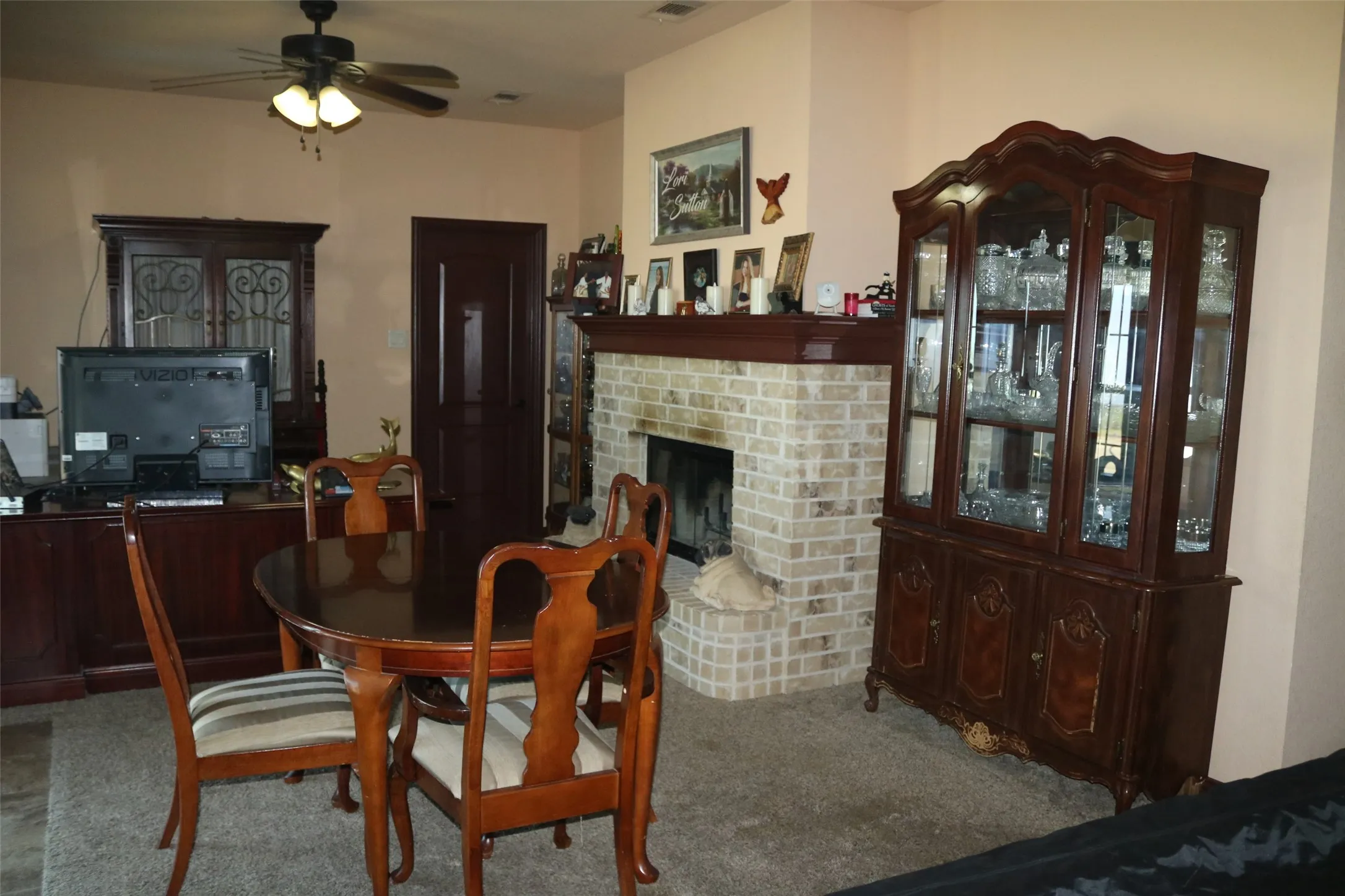Built-in brick fireplace with wood mantel
