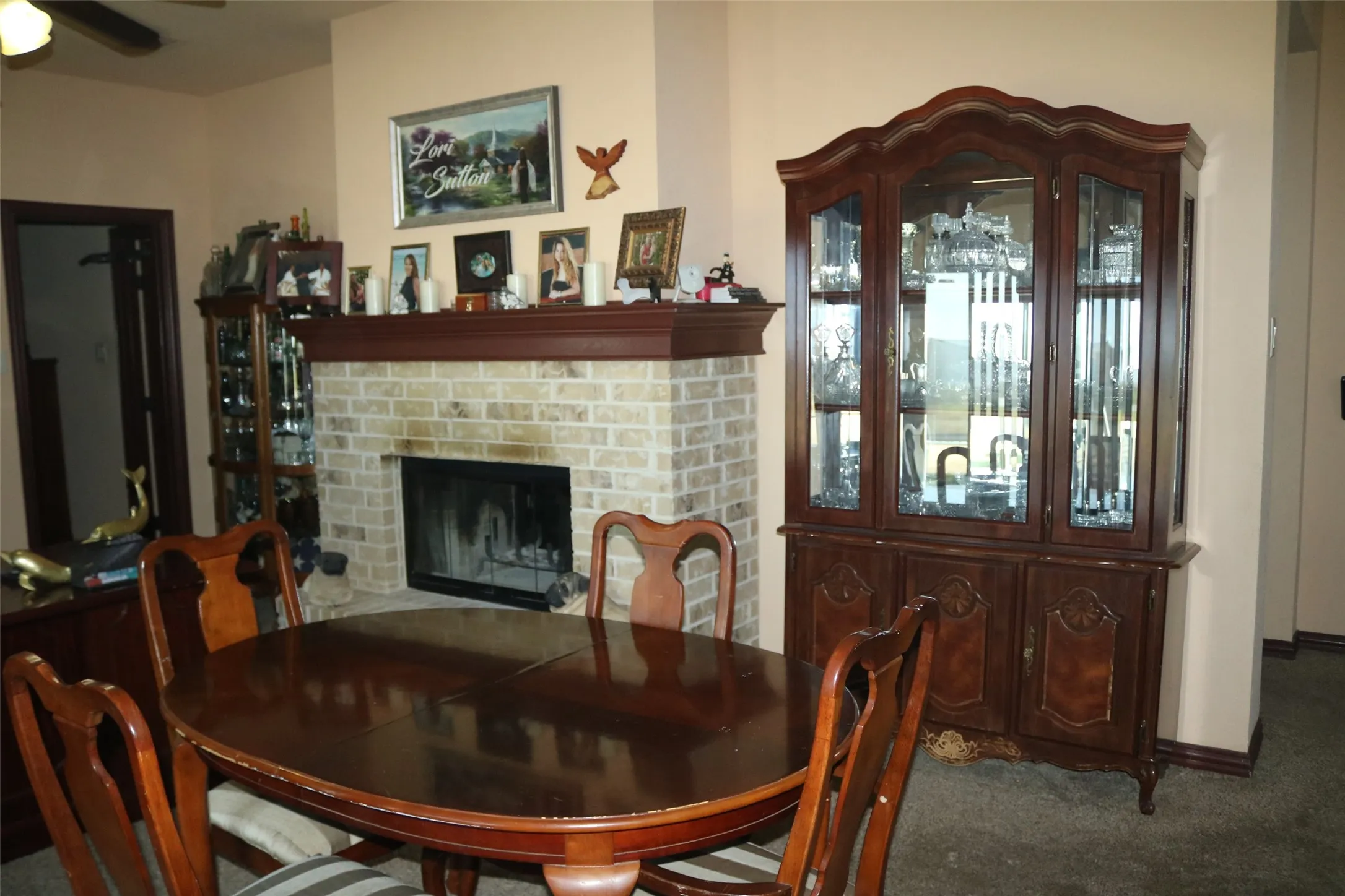 Brick-faced fireplace with a wood mantel