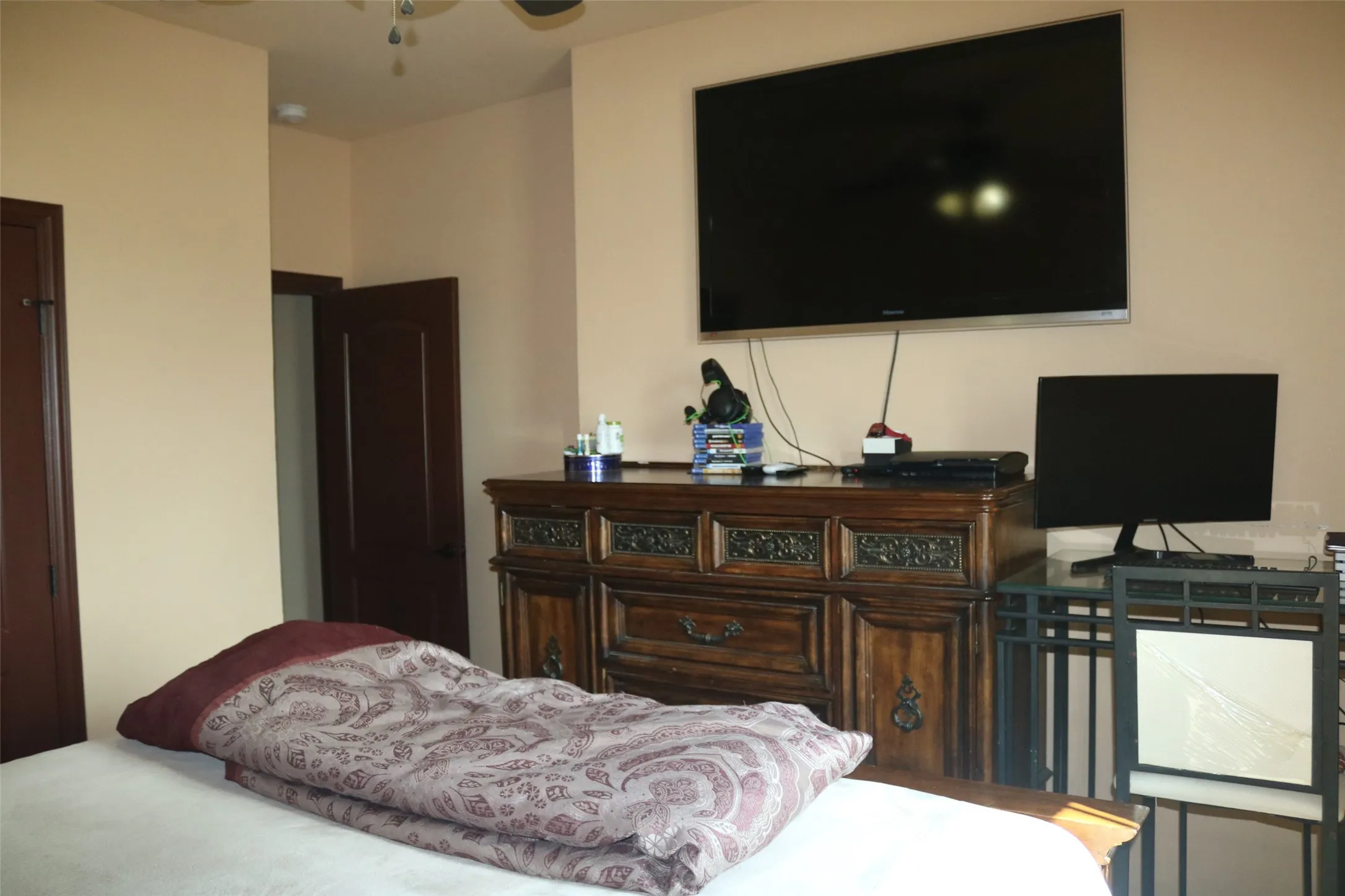 Recessed ceiling lighting, dark wood-finish interior doors, and a ceiling fan with integrated lighting