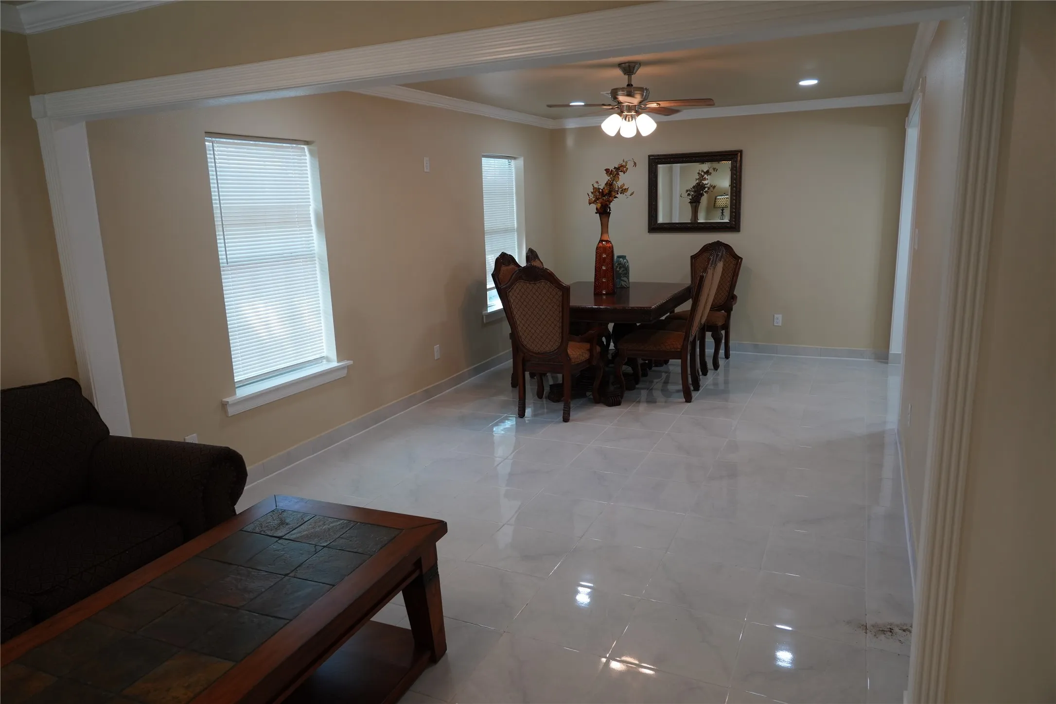 Recessed lighting, ceiling fan with light fixture, decorative trim, and tile flooring