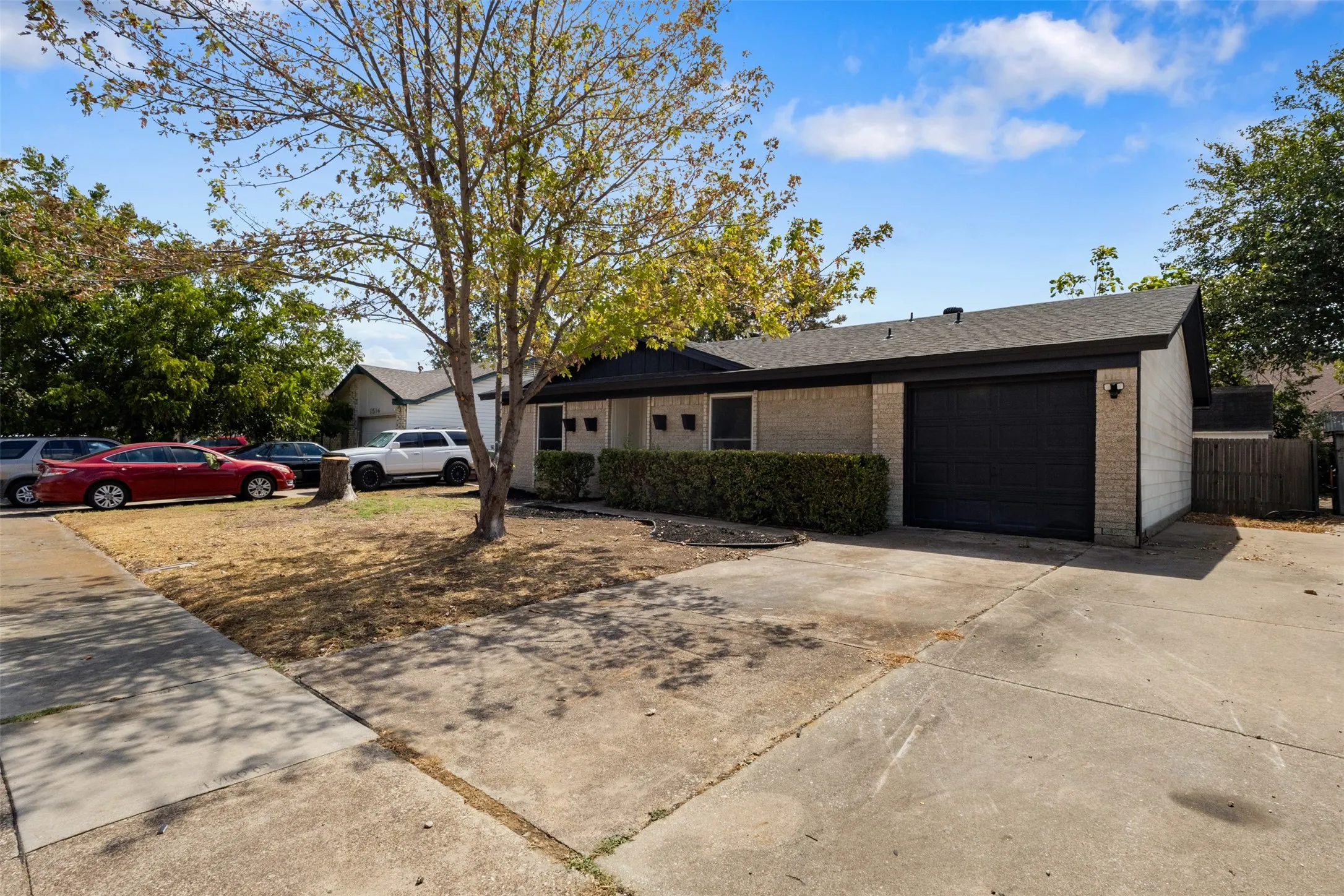 Brick facade with a dark roof and an attached garage