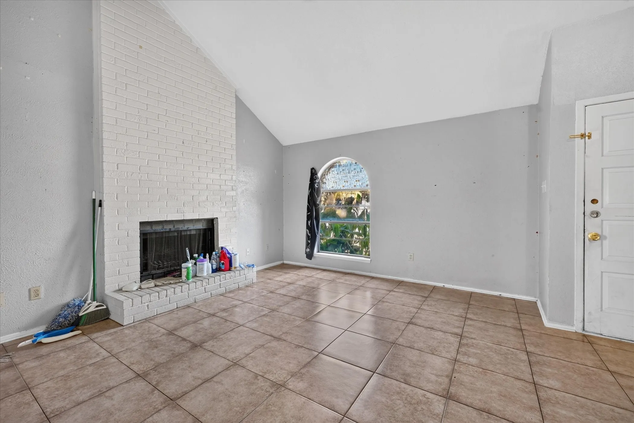 Vaulted ceiling above a painted brick fireplace