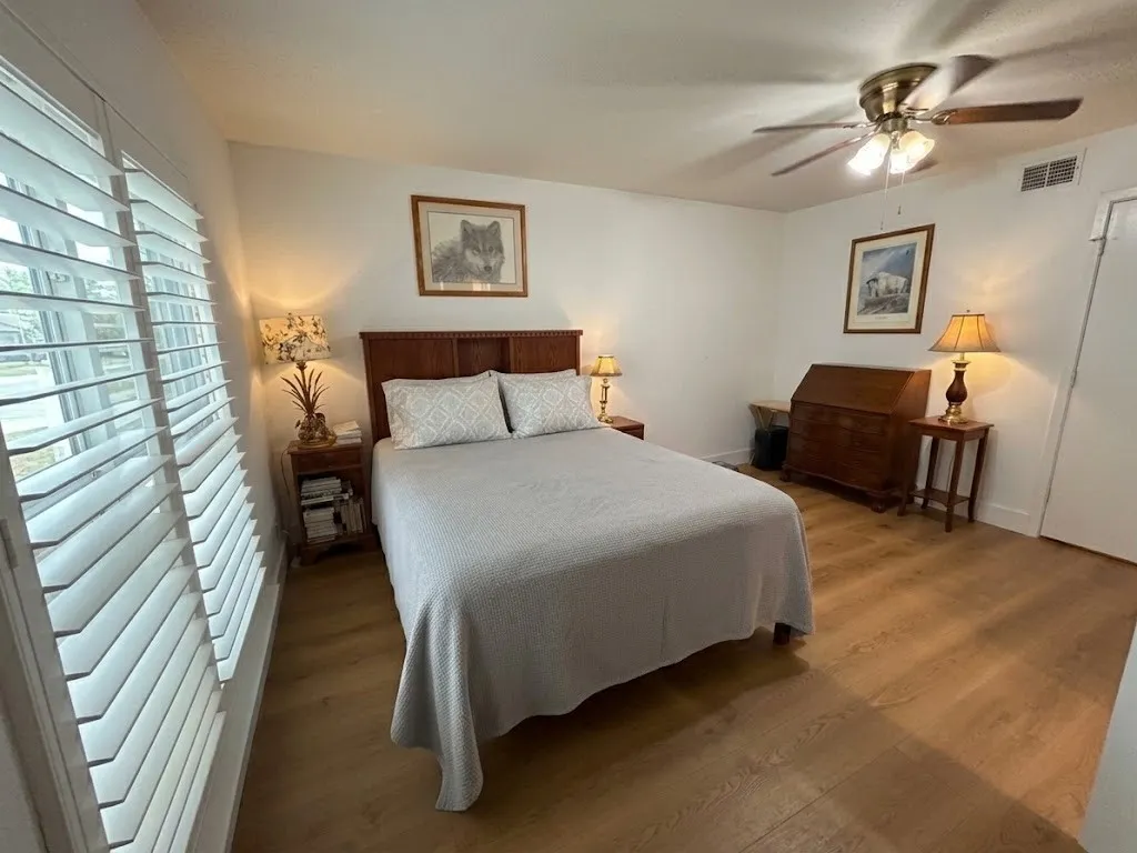 Primary bedroom downstairs. Staged with virtual bedding here.