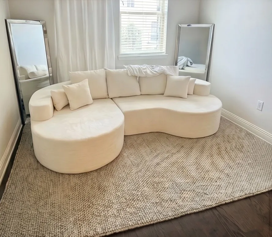 Dark wood-finish flooring, white walls, and a window with blinds