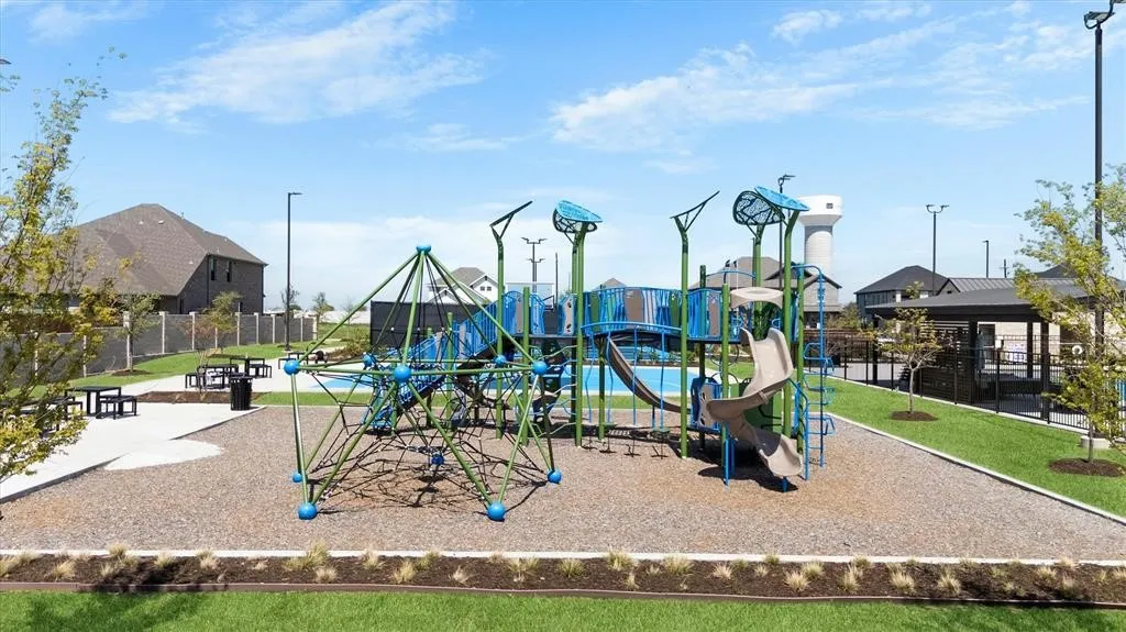 Community playground featuring multiple play structures, a climbing dome, and a slide