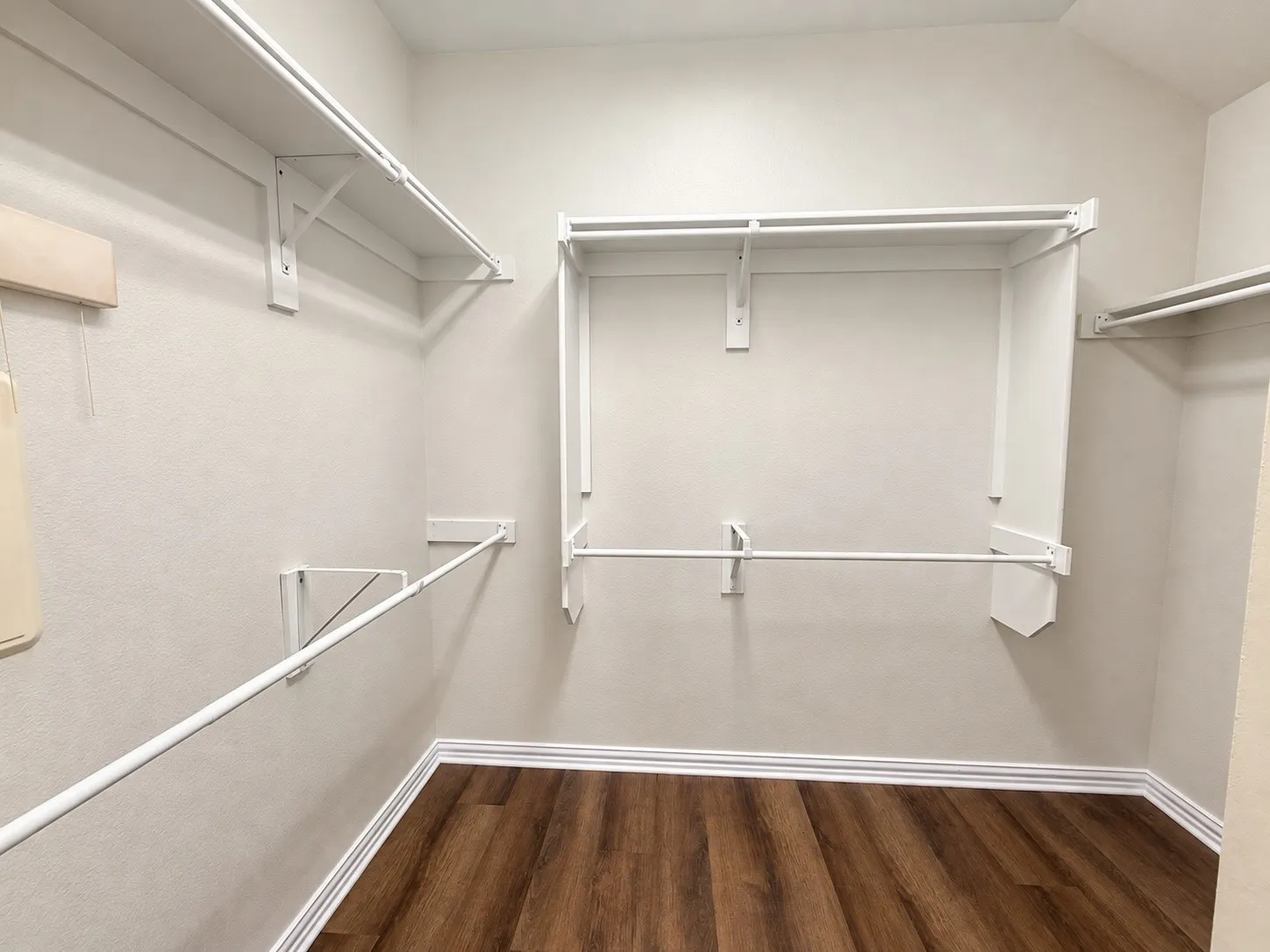 Customizable closet system featuring multiple hanging rods and shelving