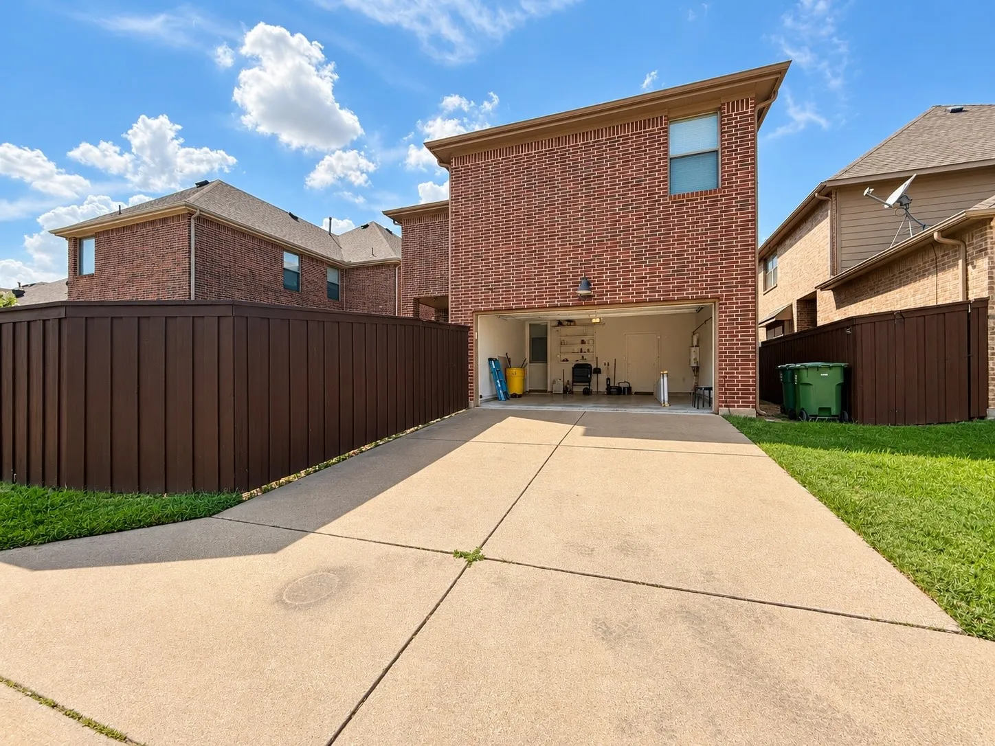 Brick exterior with an attached garage and concrete driveway