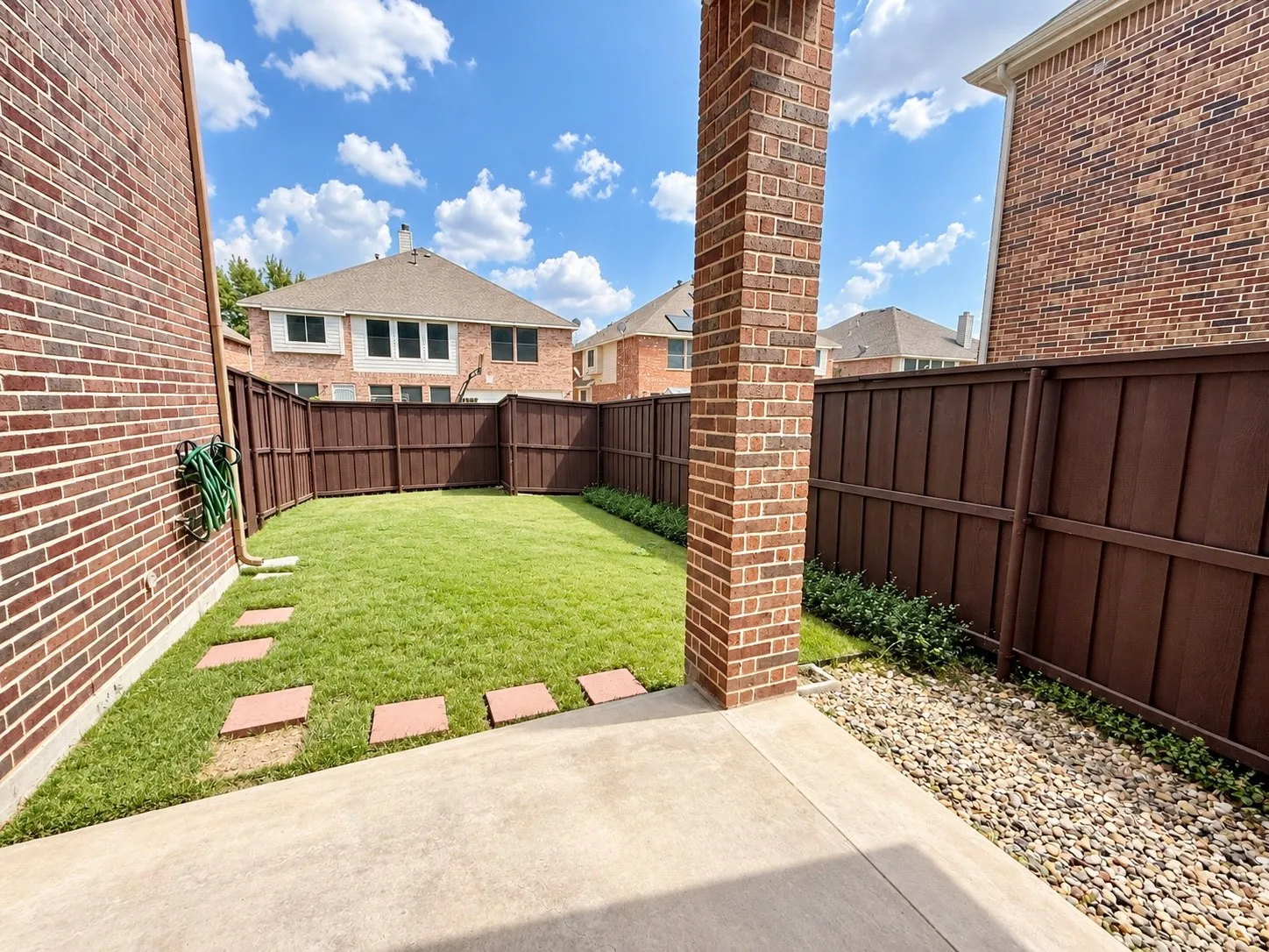 Private fenced yard featuring a concrete patio