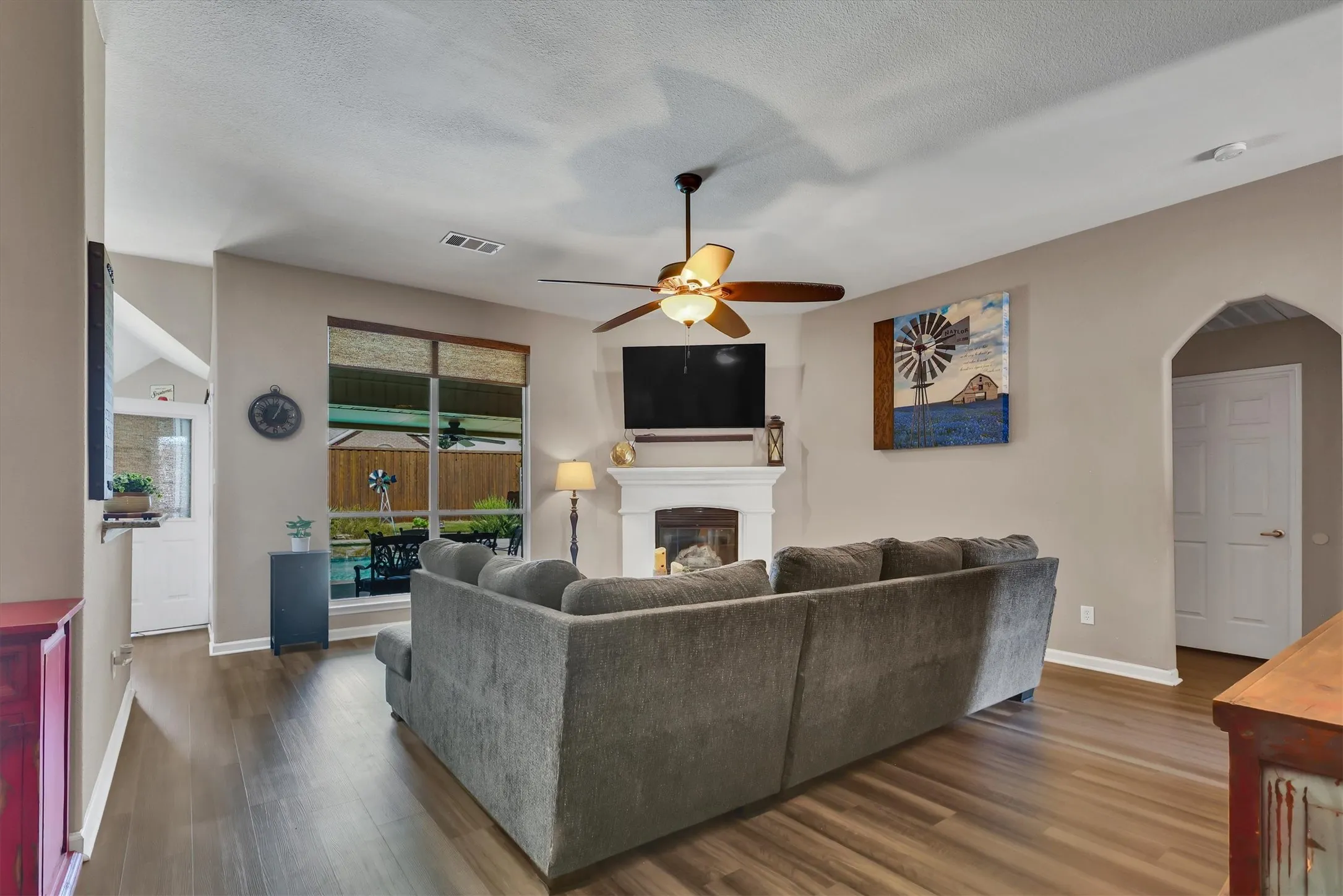 Wood-finish flooring, recessed lighting, and a ceiling fan with light fixture