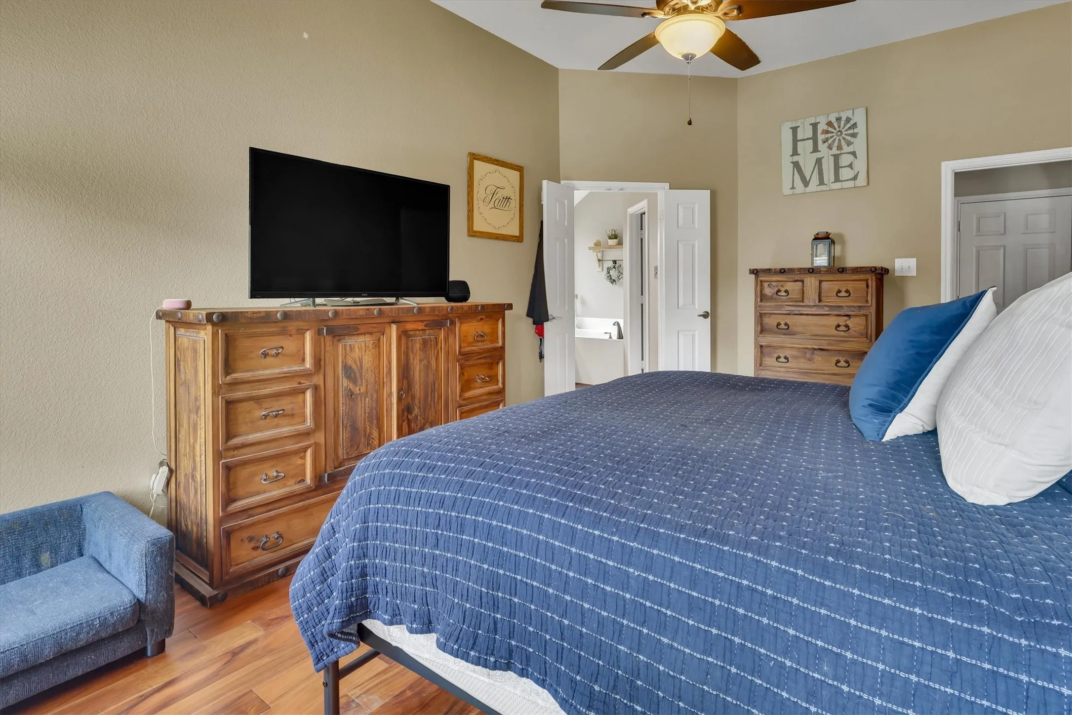 Wood-finish flooring with a ceiling fan overhead