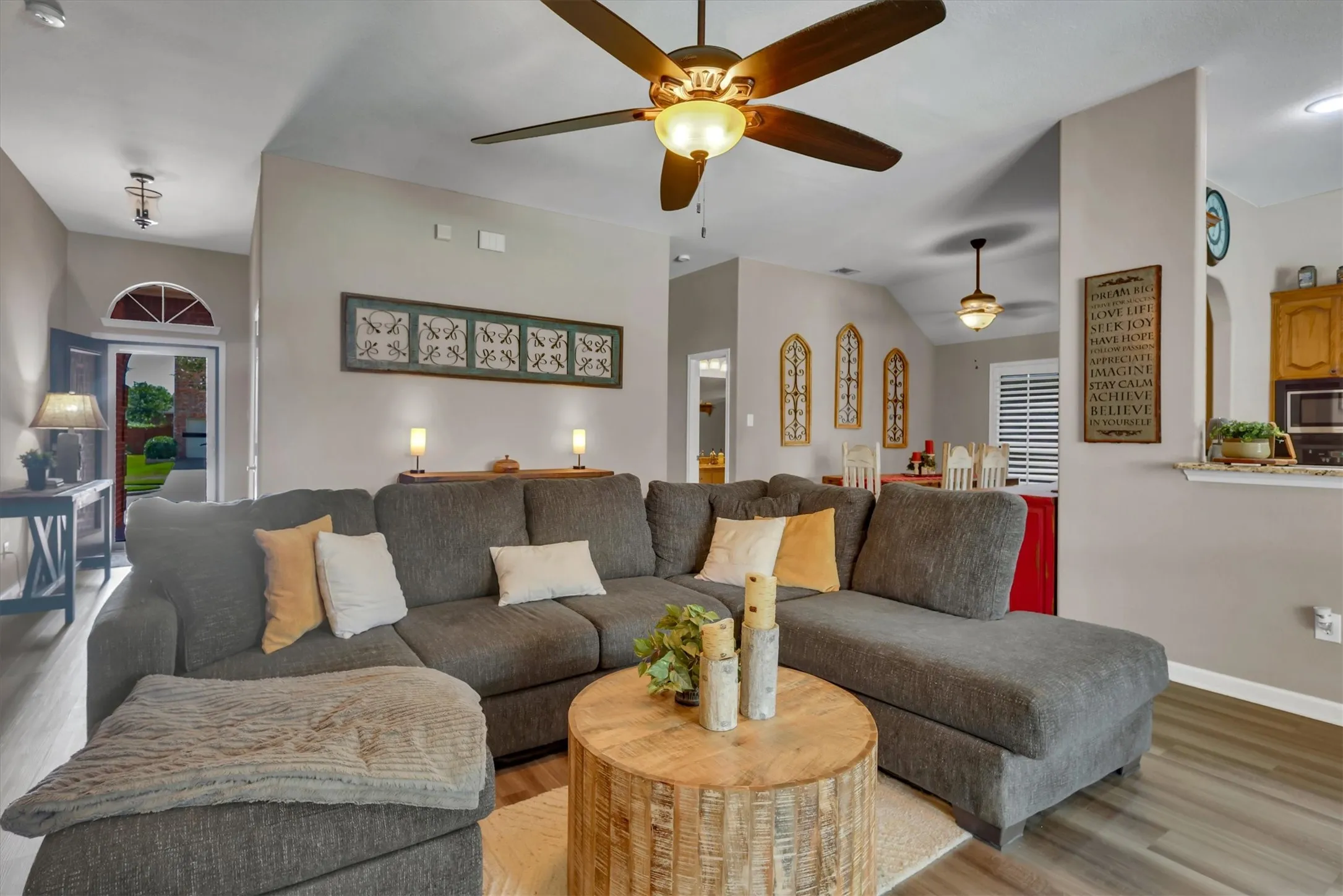 Vaulted ceilings, wood-finish flooring, ceiling fan, and recessed lighting