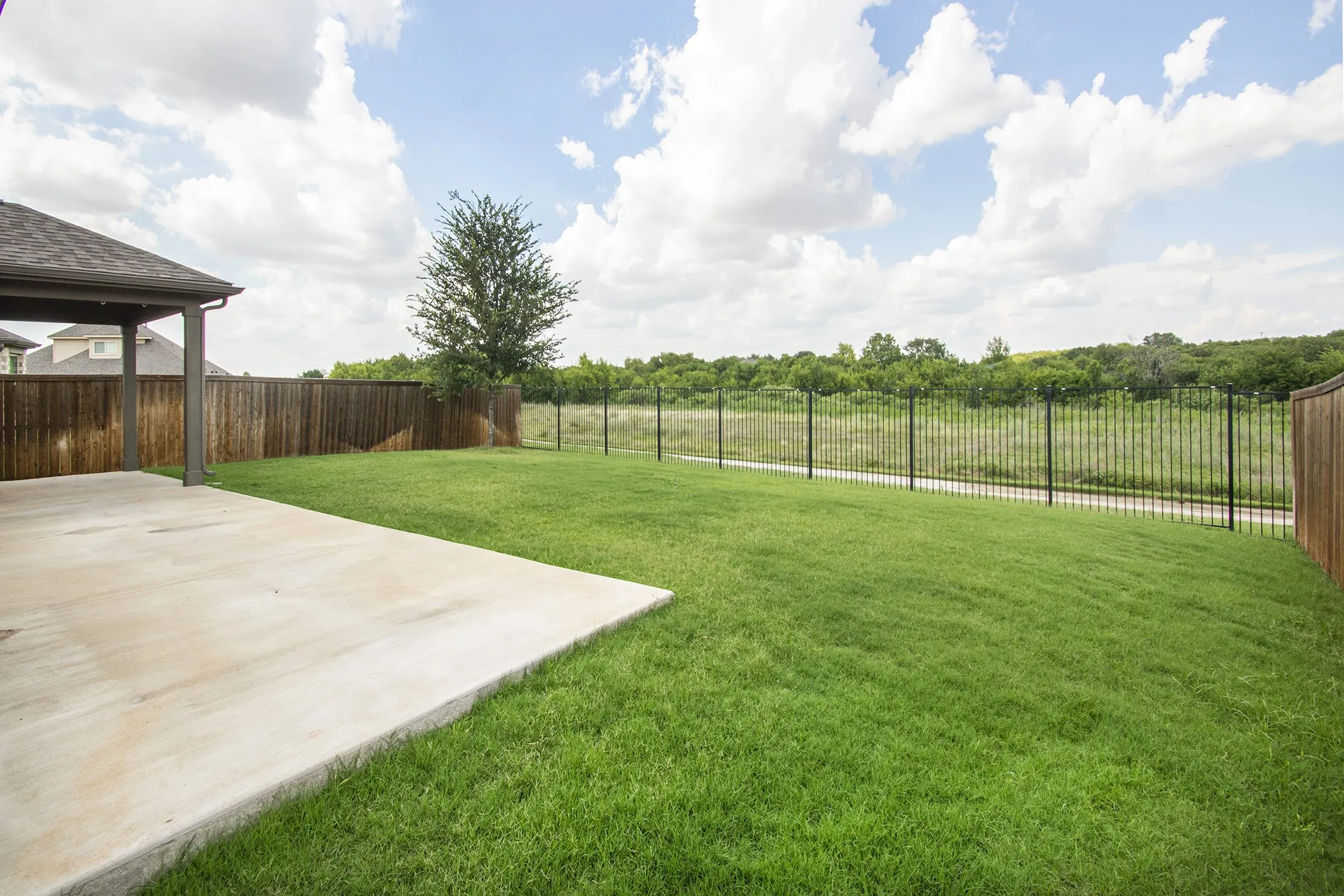 Fenced backyard featuring a patio