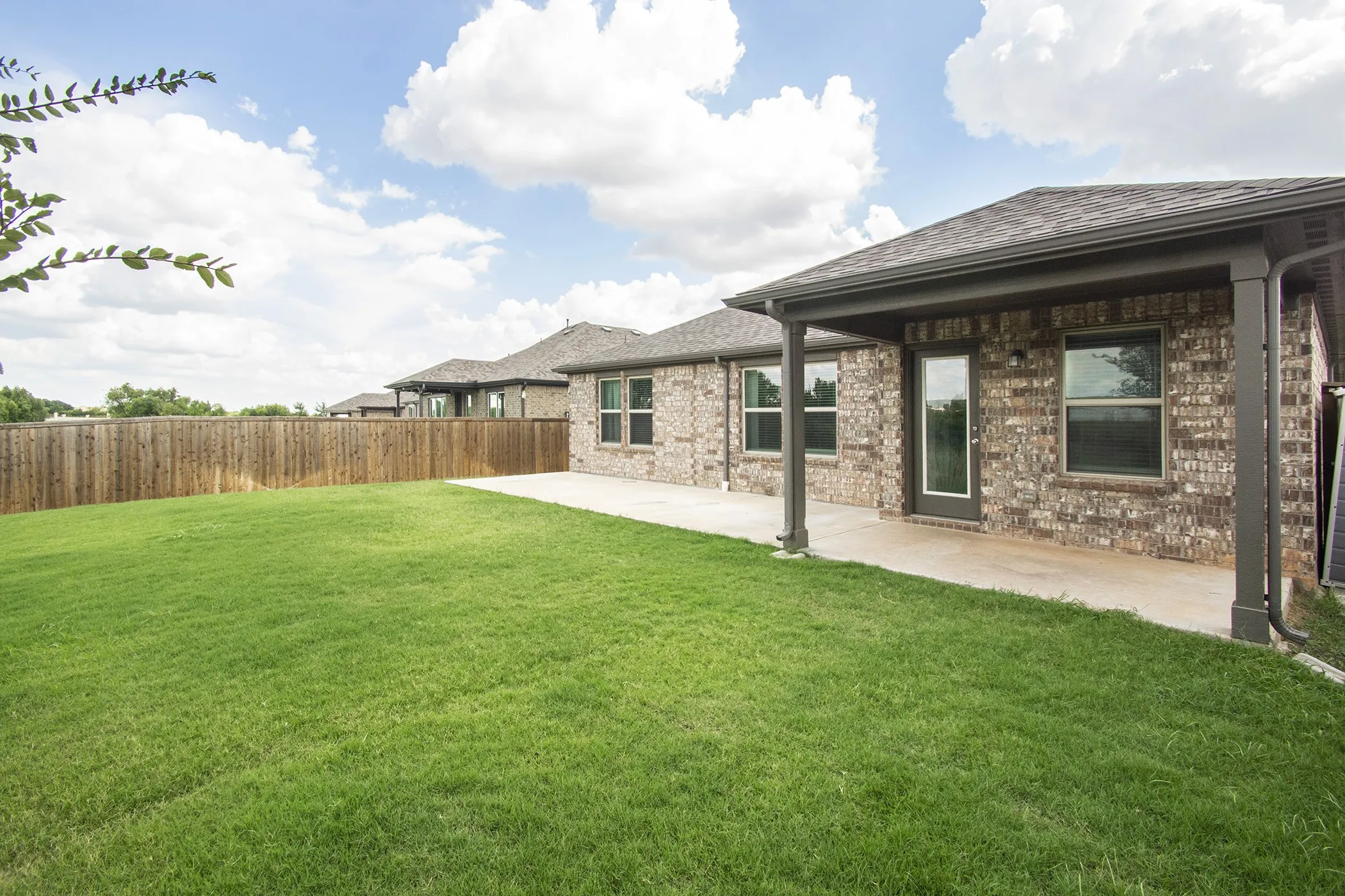 Fenced backyard with a patio area