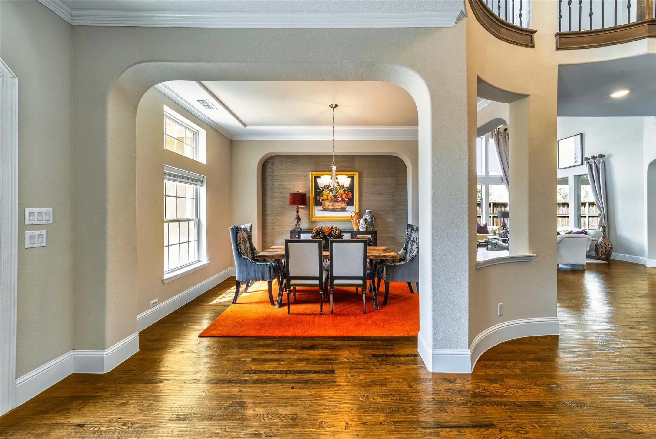 Hardwood flooring, arched doorways, crown molding, double-pane windows, and a built-in chandelier