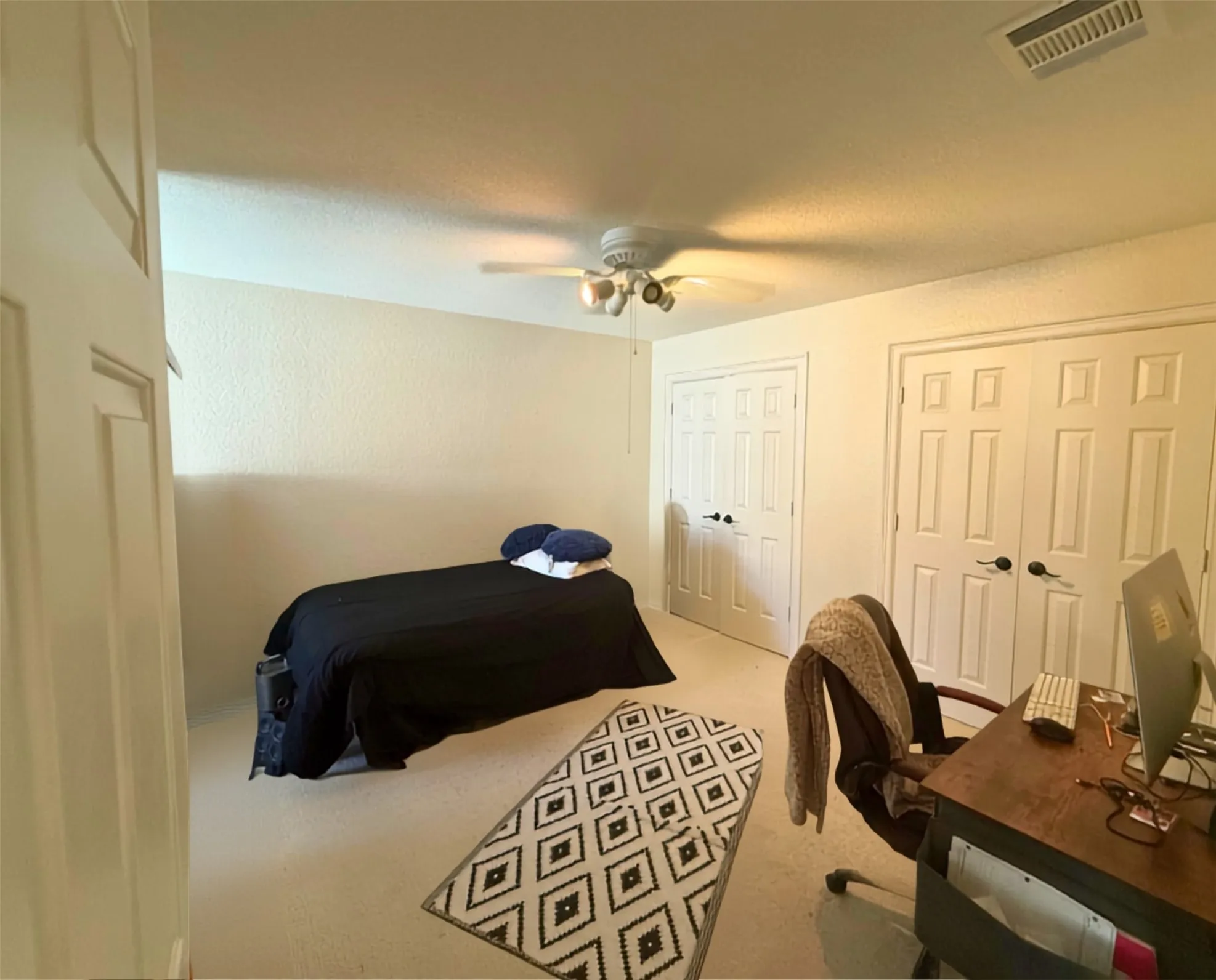 Upstairs bedroom is spacious with double closets.