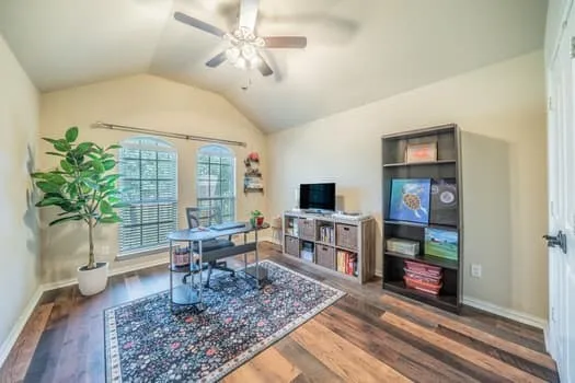 Vaulted ceiling with ceiling fan, wood-finish flooring, and arched windows with blinds, front outdoor view