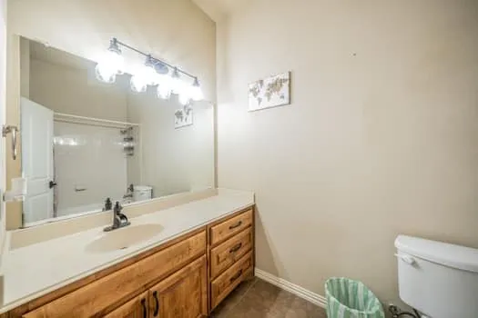 Long vanity with an integrated sink and wood-finish cabinetry