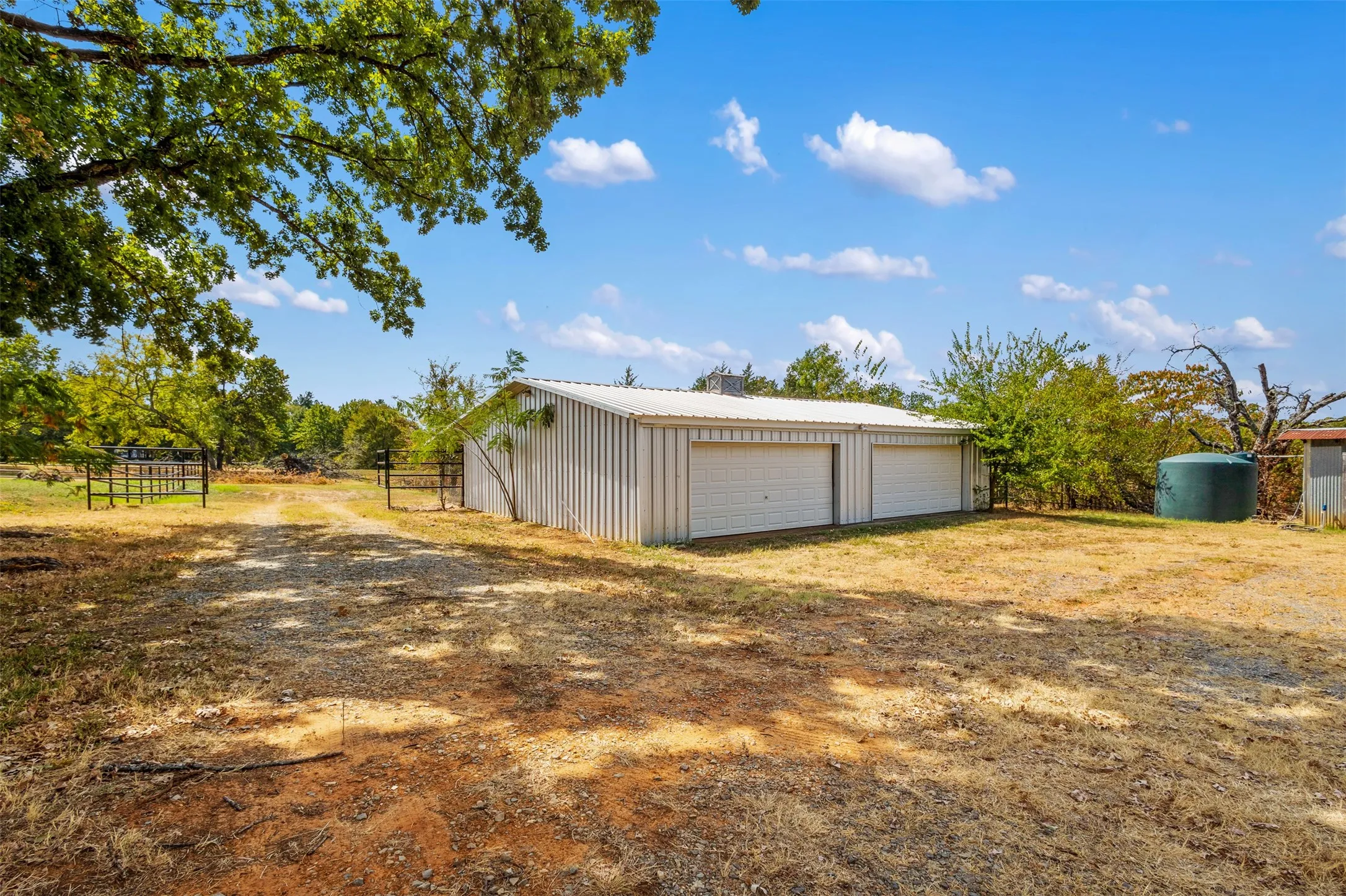 Detached metal building with two garage doors and a metal roof
