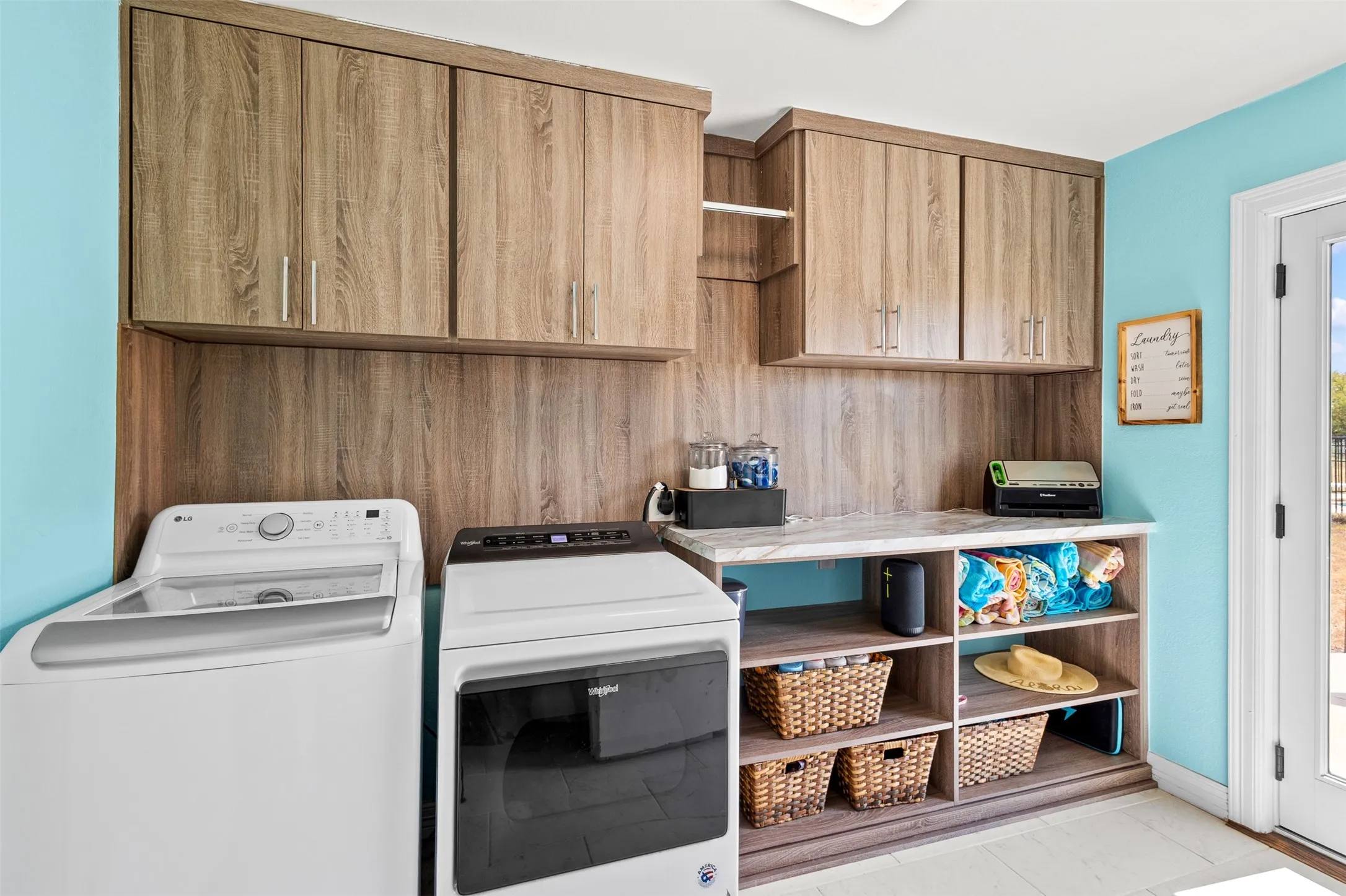 Wood-finish cabinetry and shelving with a light-toned countertop