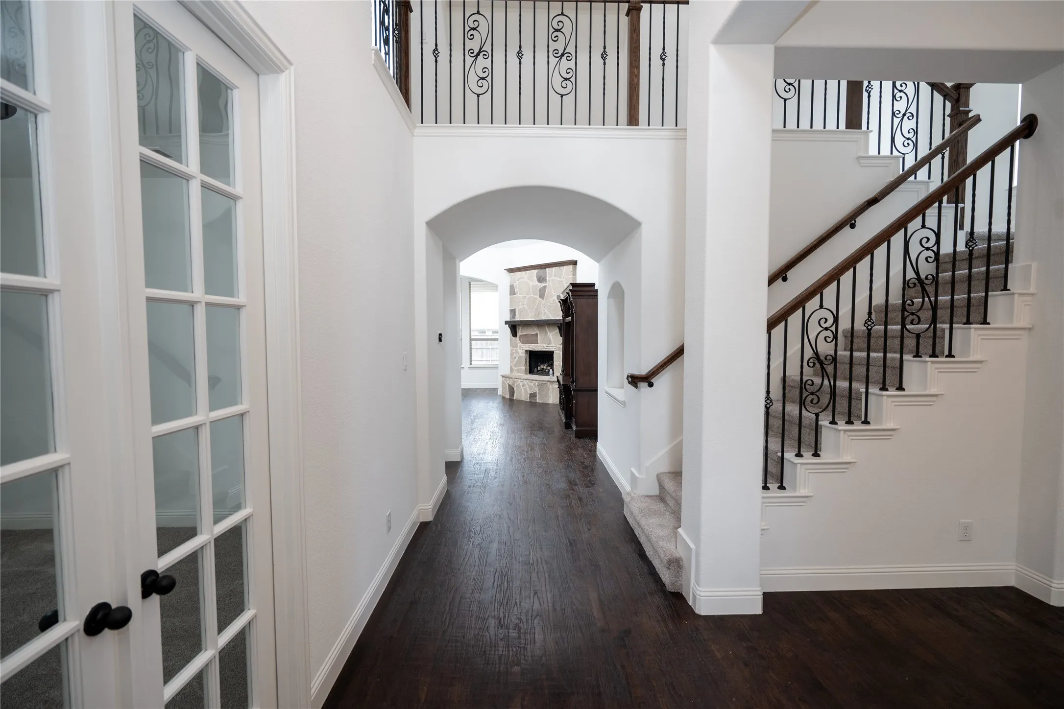 Dark wood-finish flooring throughout the main corridor