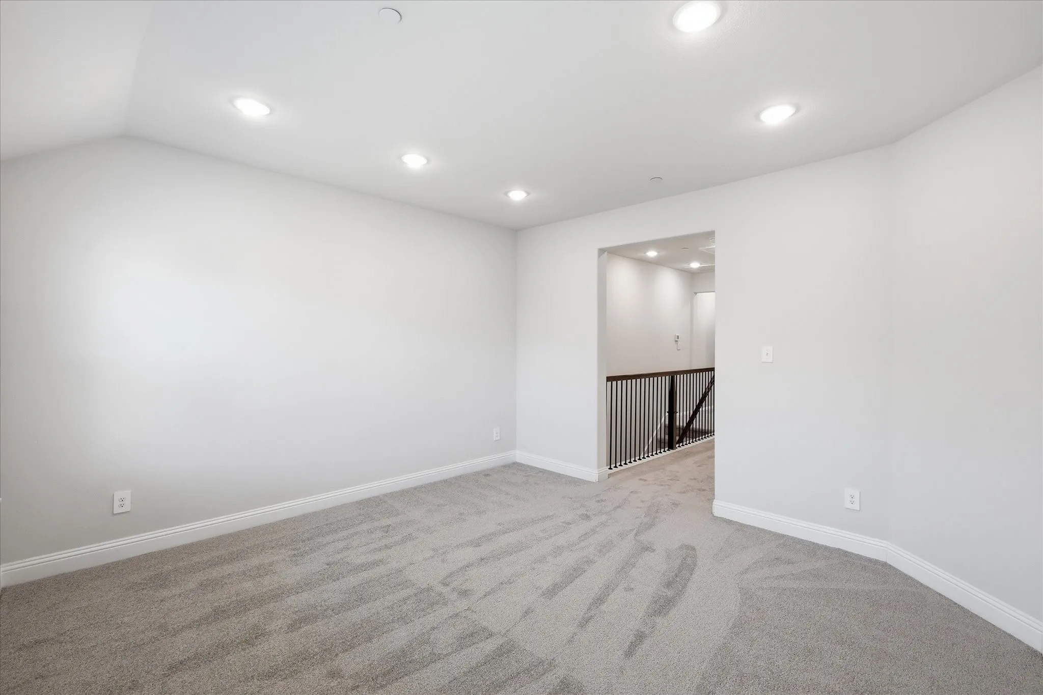 Loft space featuring recessed lighting, light gray carpet, and white walls