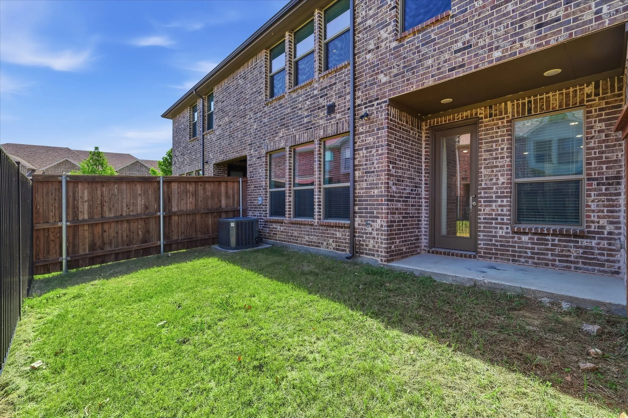 Brick exterior with multiple windows and an exterior door