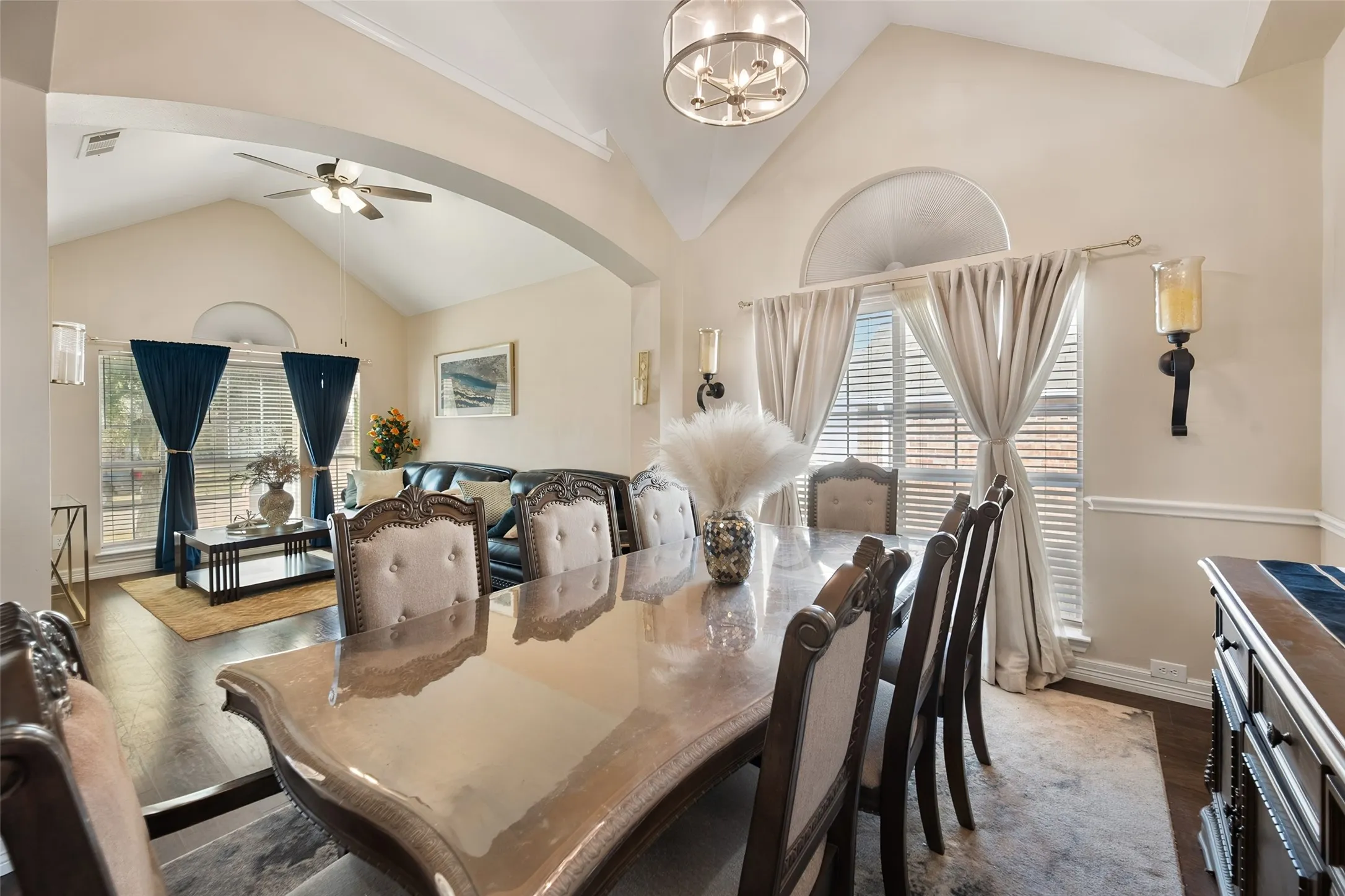 Formal Dining area featuring vaulted ceilings, a decorative chandelier, and an arched window