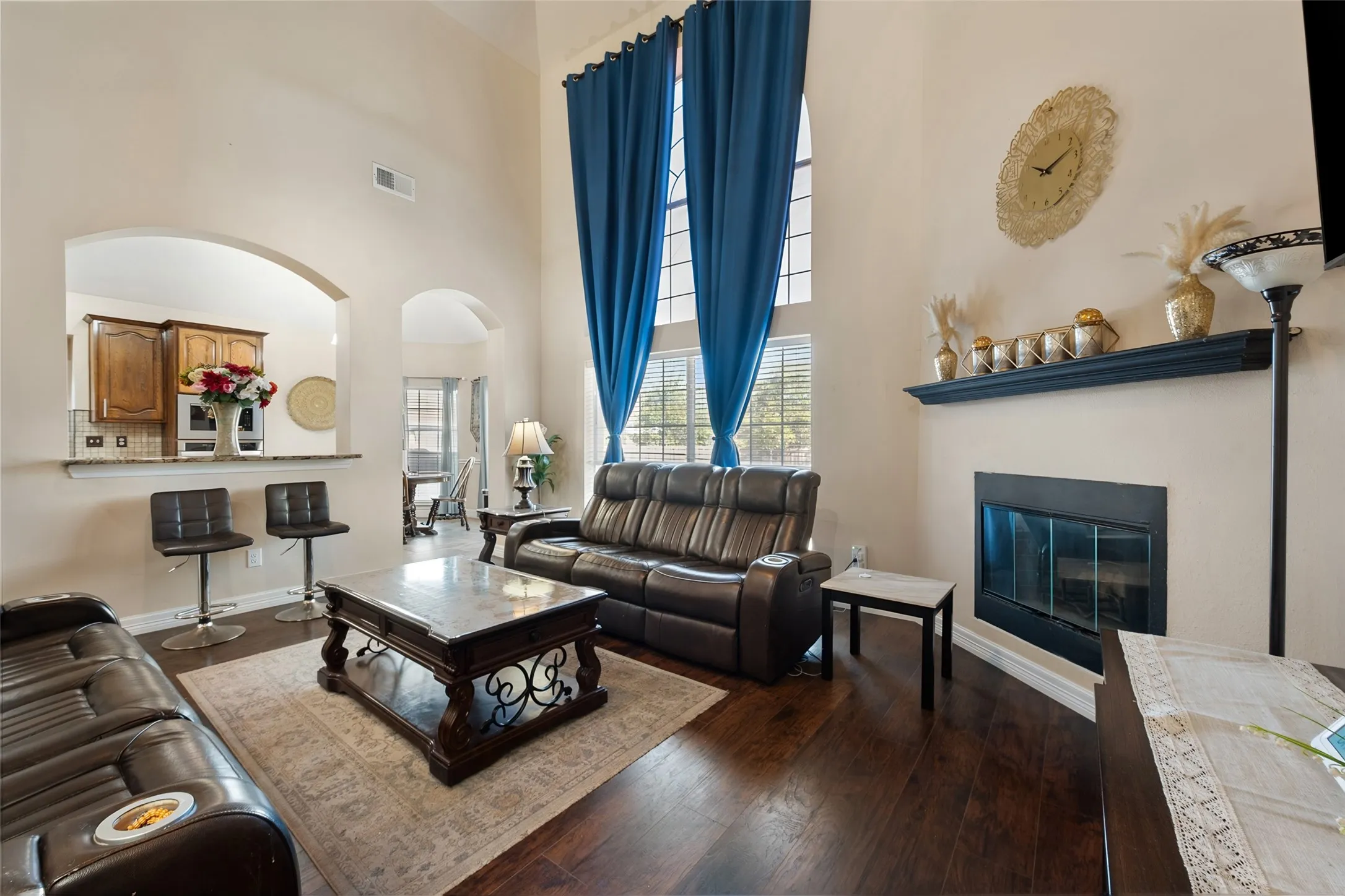 Soaring ceilings and wood-finish flooring complement the built-in fireplace