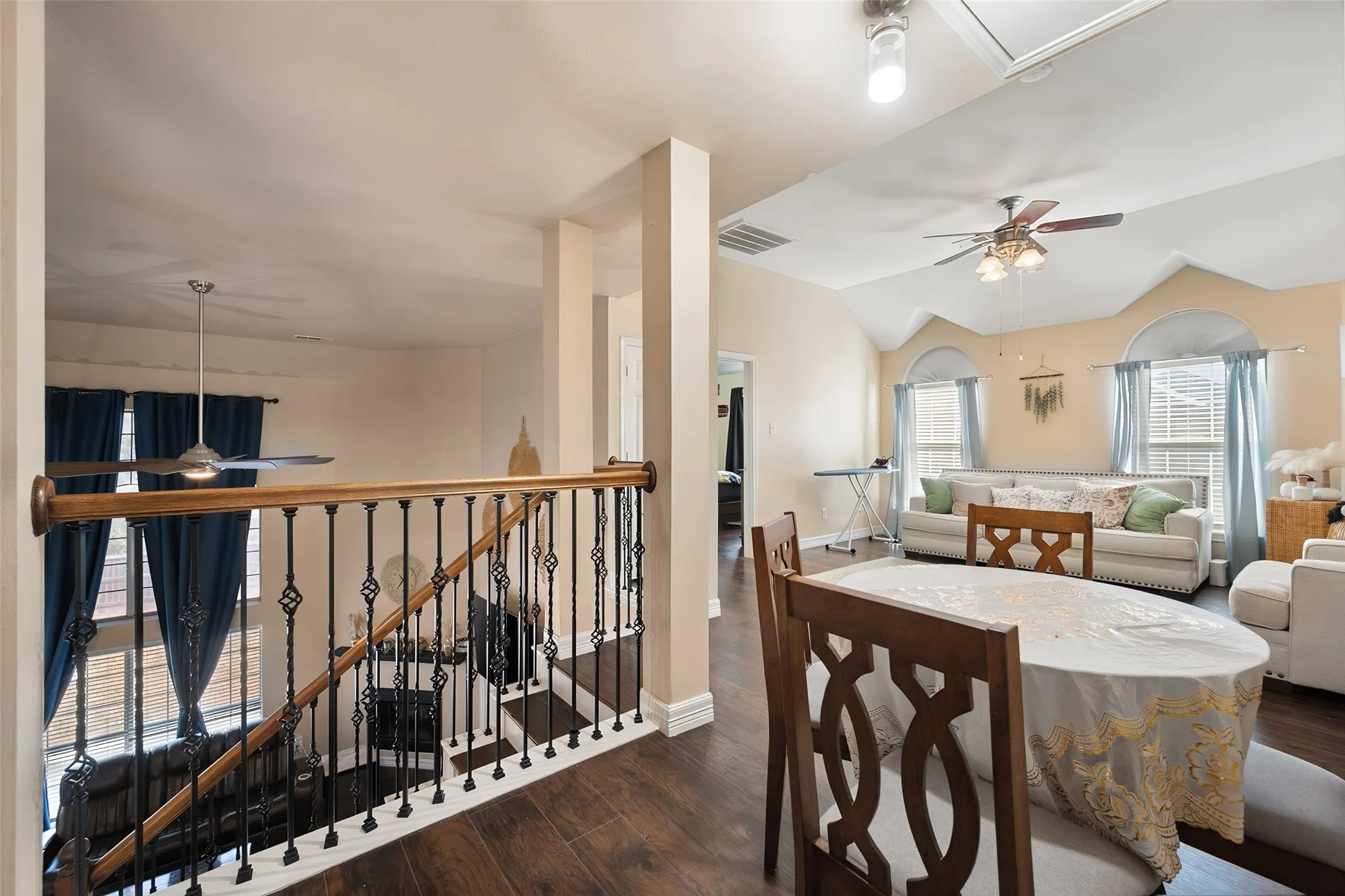 This is a third living room area up stairs-Open concept living area with wood-finish flooring, vaulted ceilings, and a ceiling fan