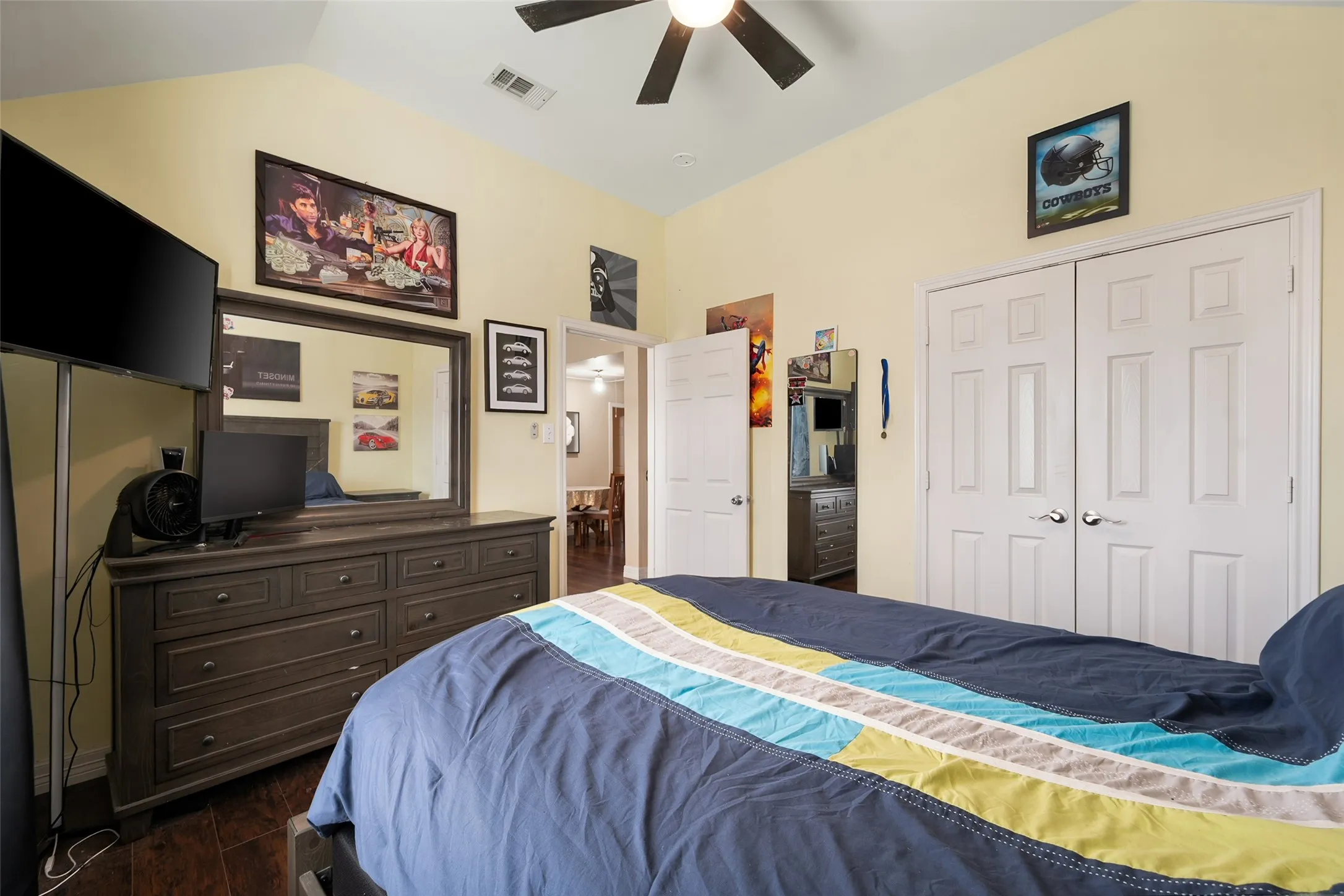 upstairs bedroom, Vaulted ceiling with a ceiling fan, wood-finish flooring, and double-door closet