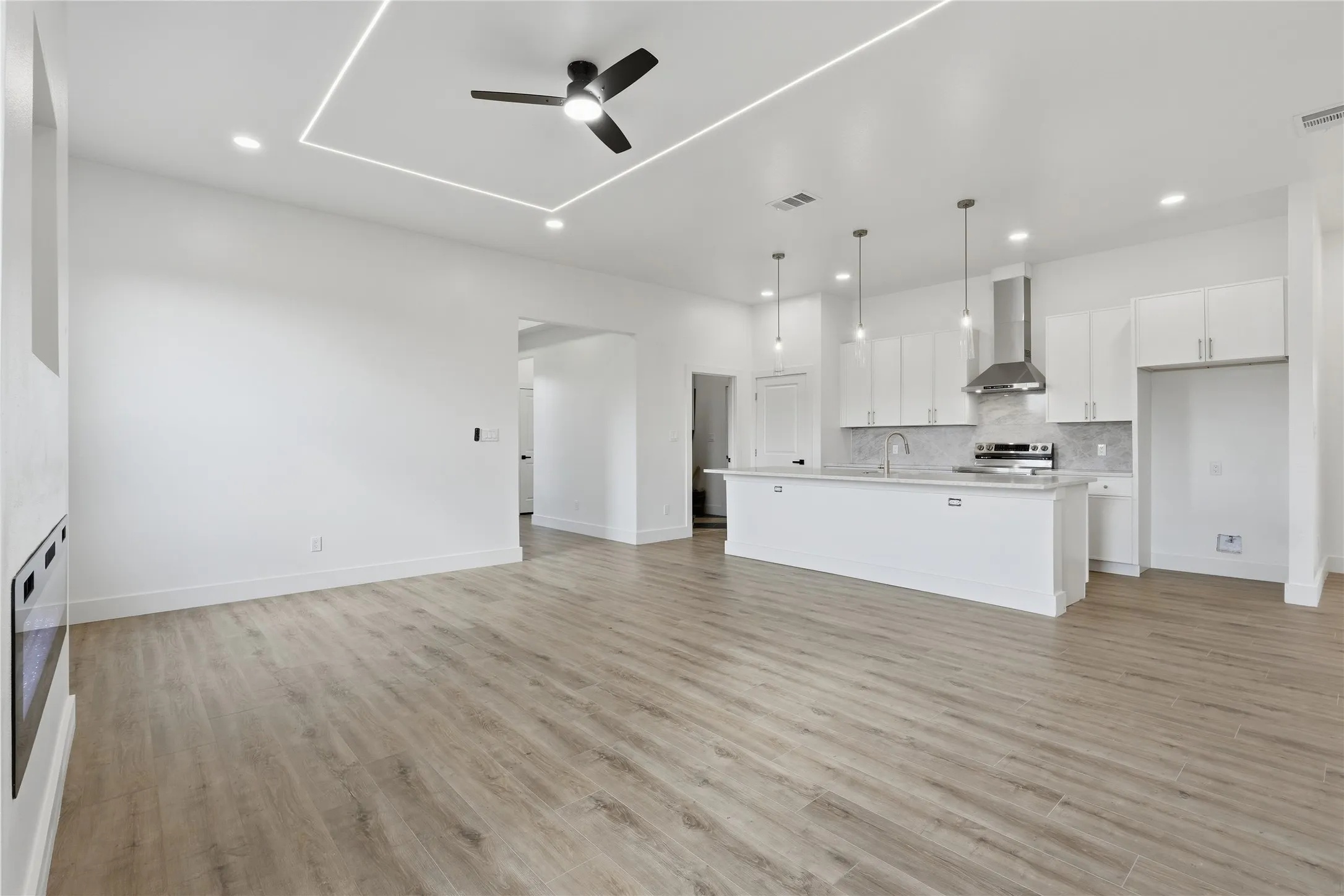 Open-concept living area featuring wood-finish flooring