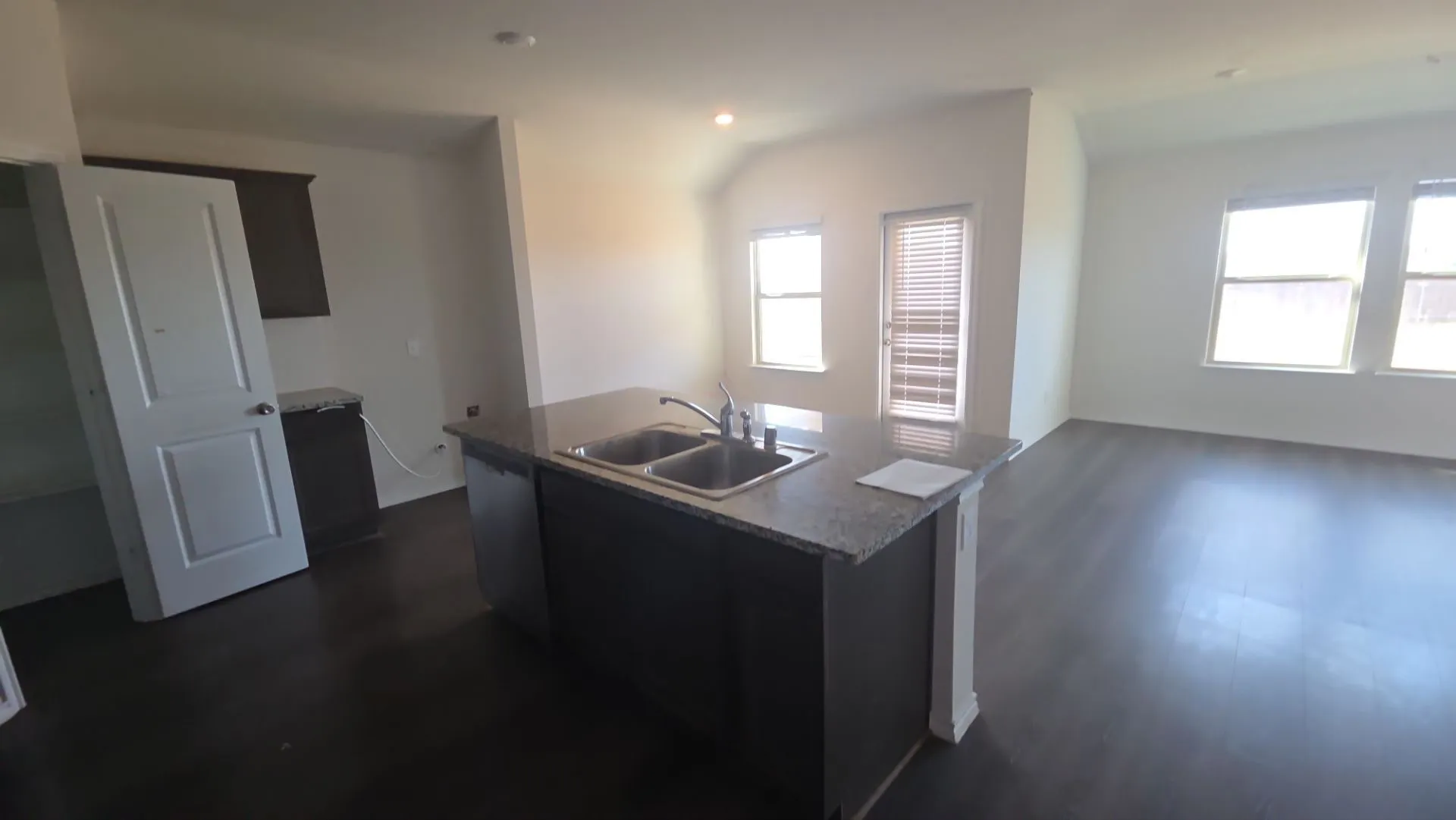Kitchen island with a double basin sink and stone finish countertop