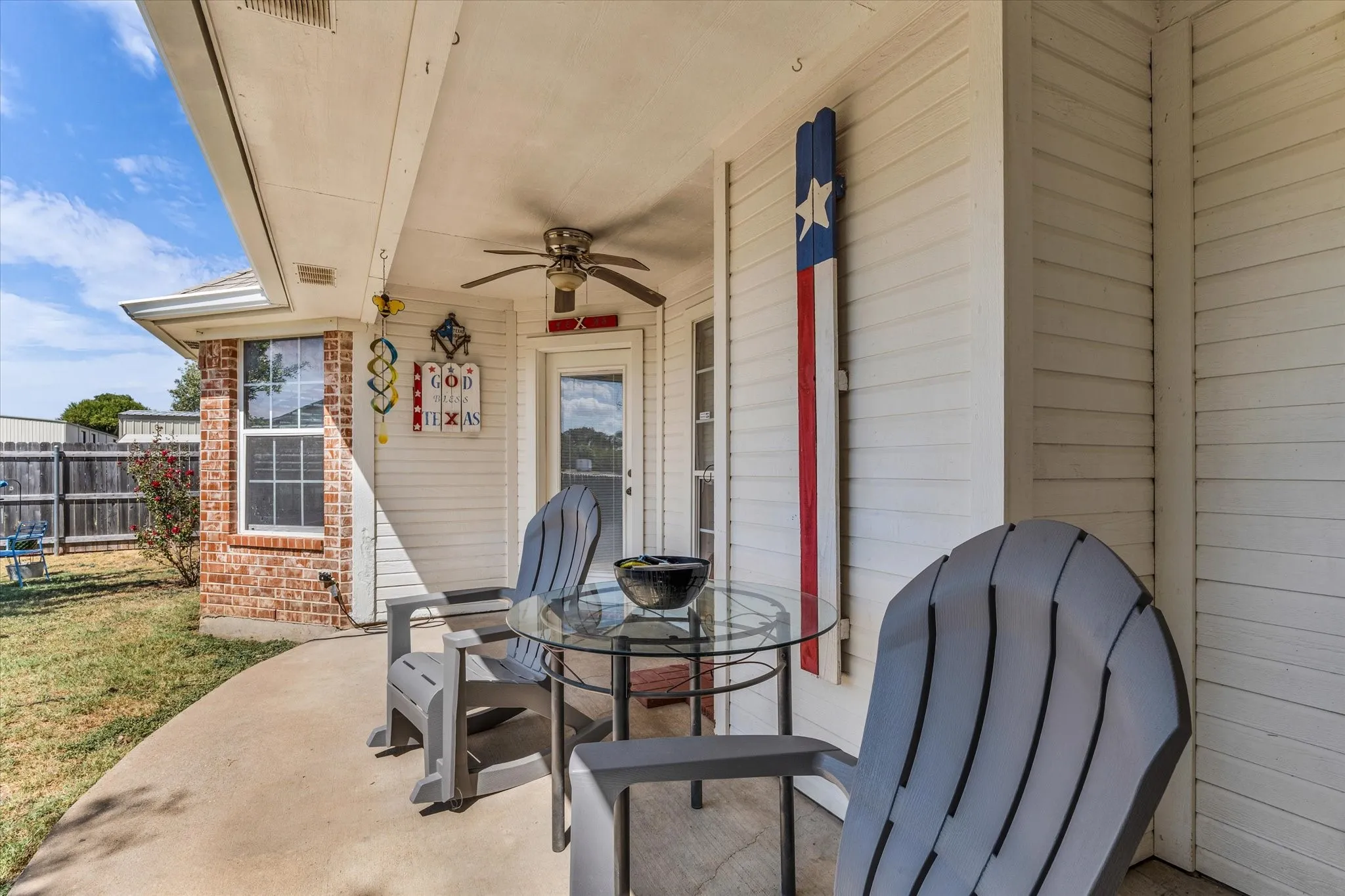 Covered patio with a ceiling fan, concrete flooring, and direct exterior access