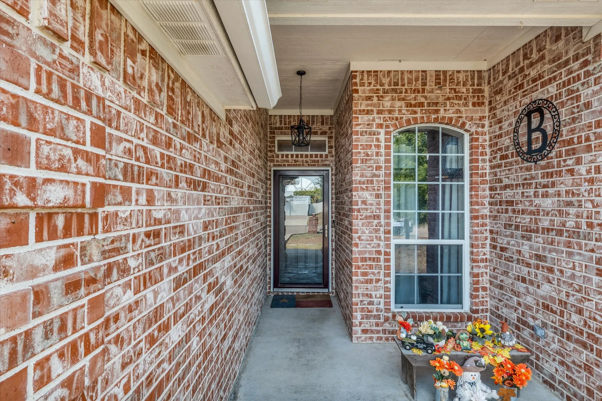 Brick exterior facade with a covered entry