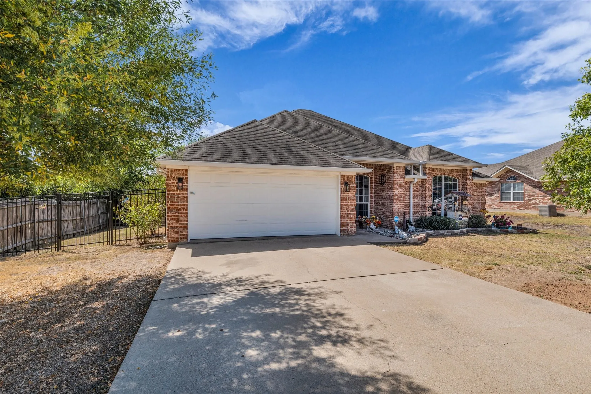 Brick exterior with a gabled roof and attached two-car garage