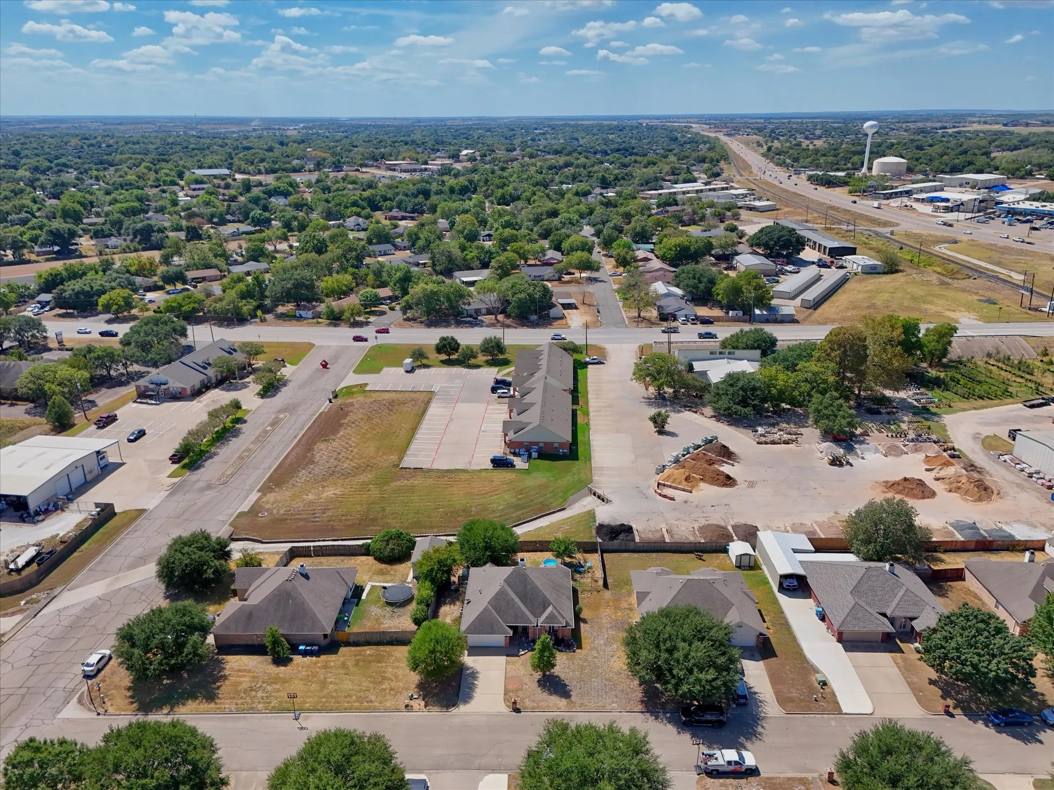 Expansive residential area featuring established homes, mature trees, and a clear sky backdrop