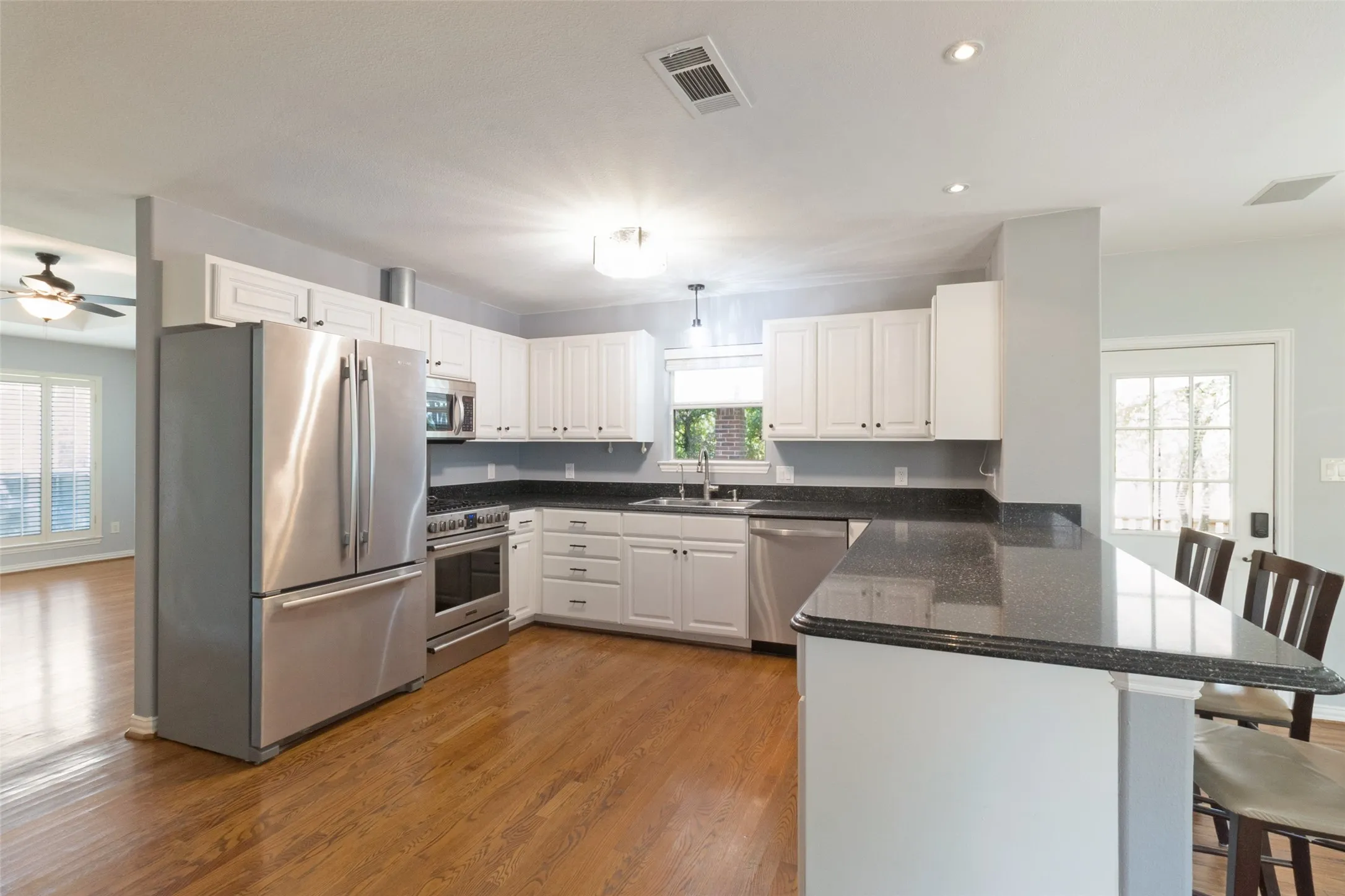 Large kitchen with stainless steel appliances and granite countertops