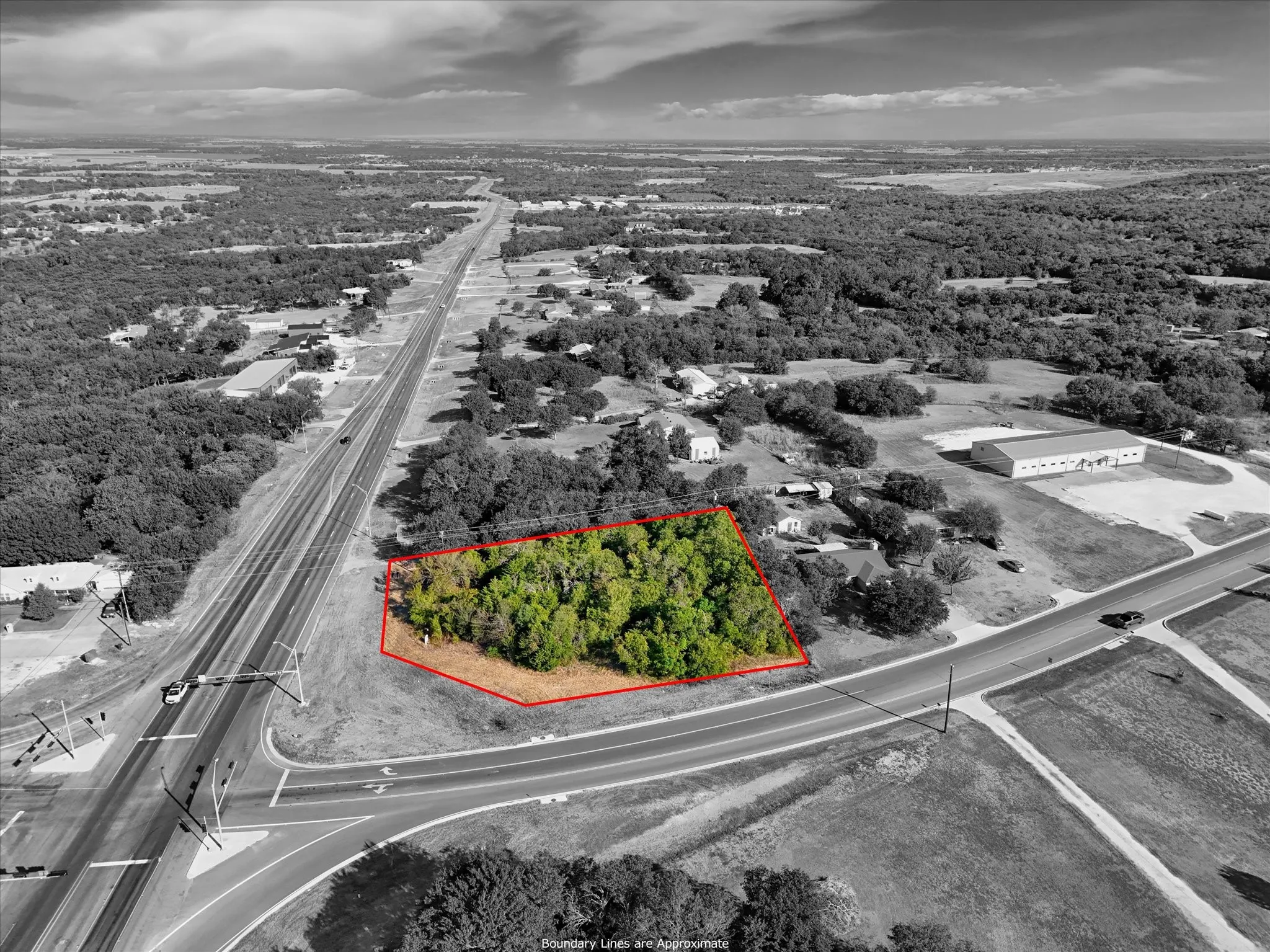 Wooded lot with mature trees, situated at a road intersection