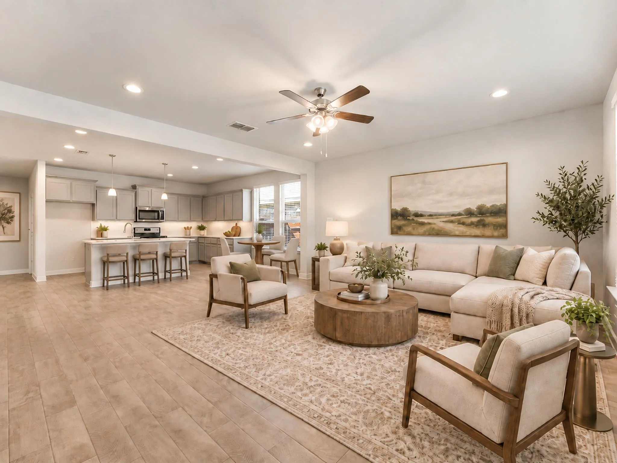 Open-concept living space featuring wood-finish flooring, recessed lighting, and a ceiling fan