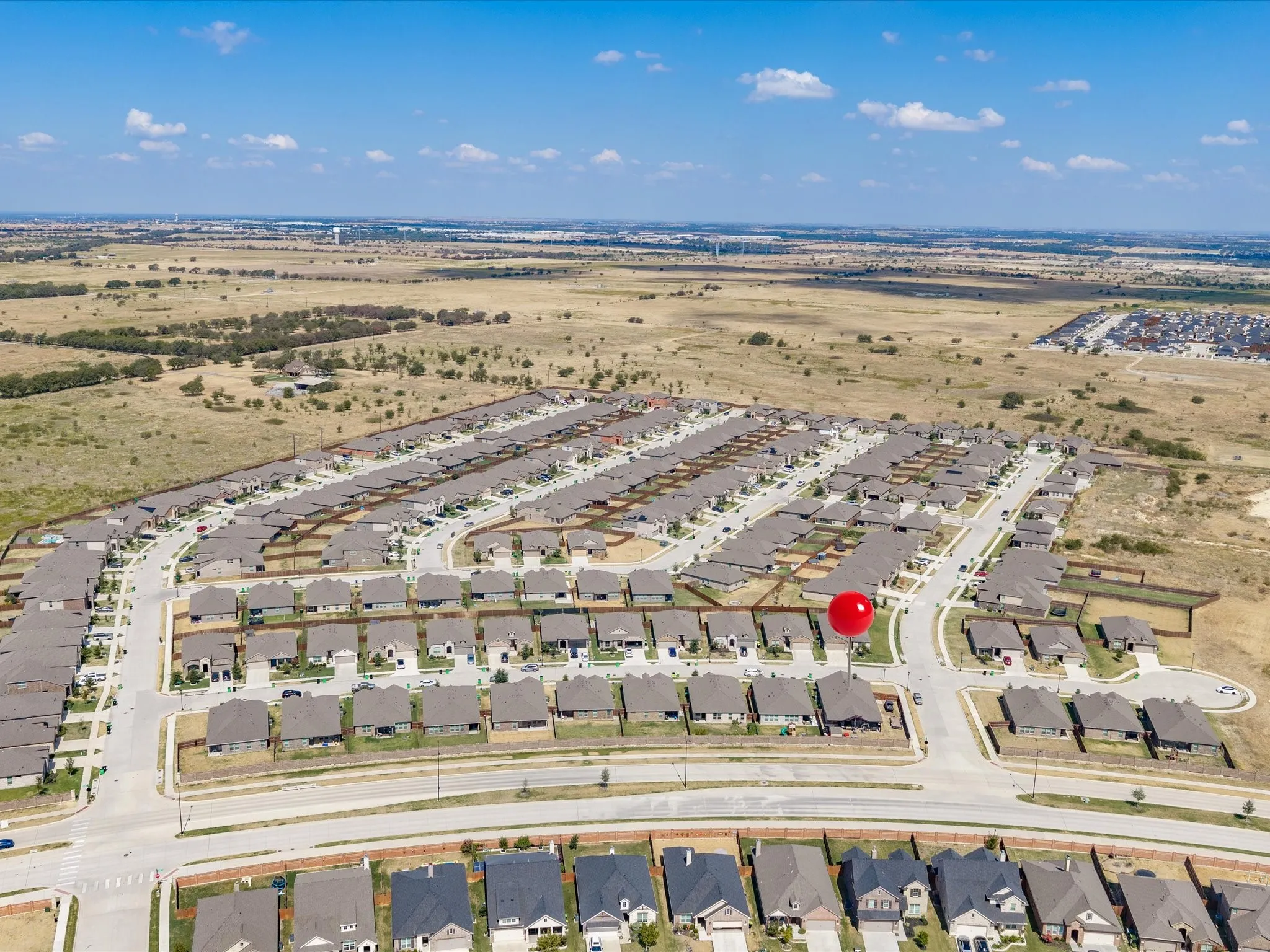 Expansive residential neighborhood with uniform housing and paved roadways