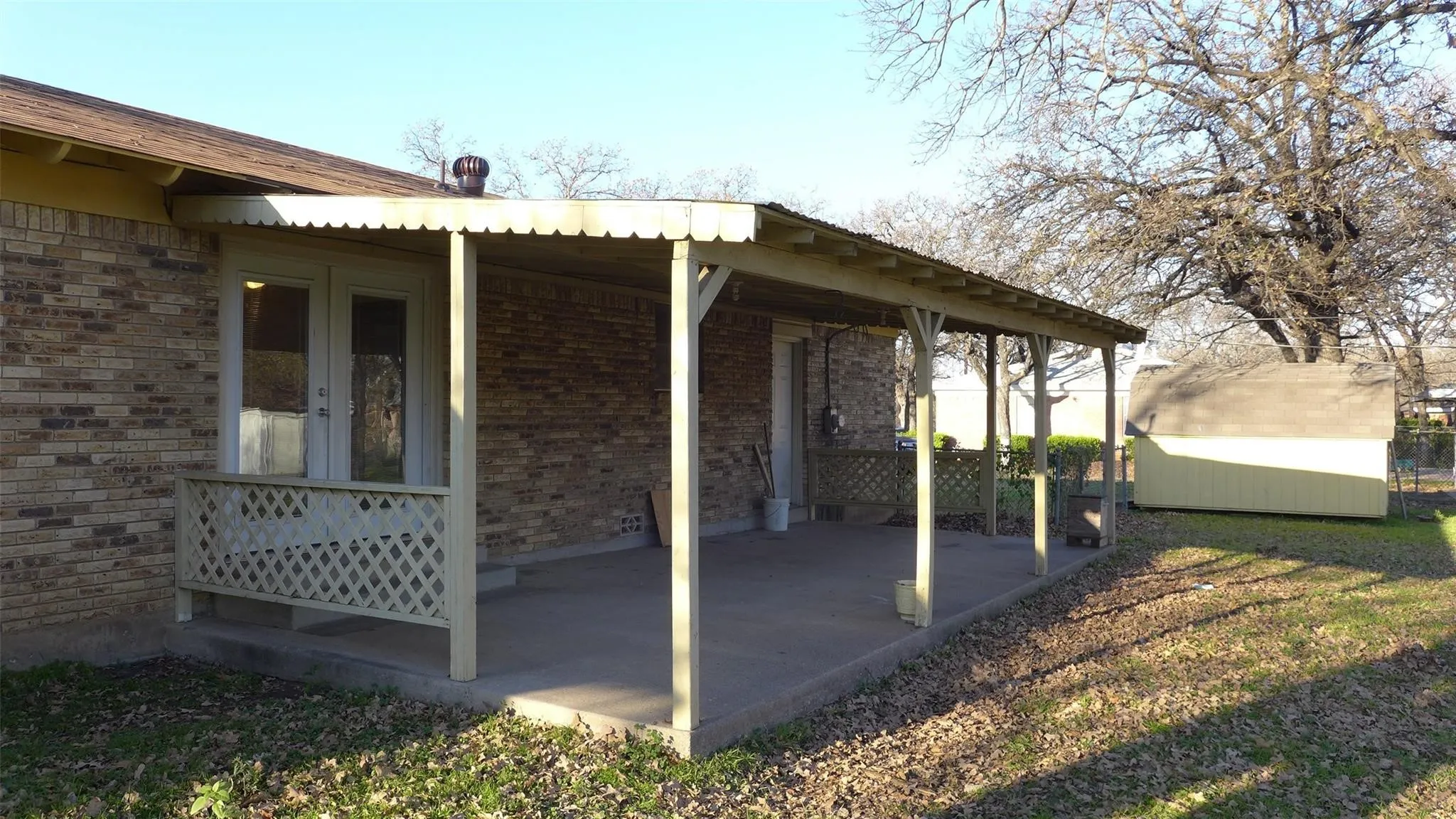 Covered patio featuring a concrete slab and decorative lattice railing
