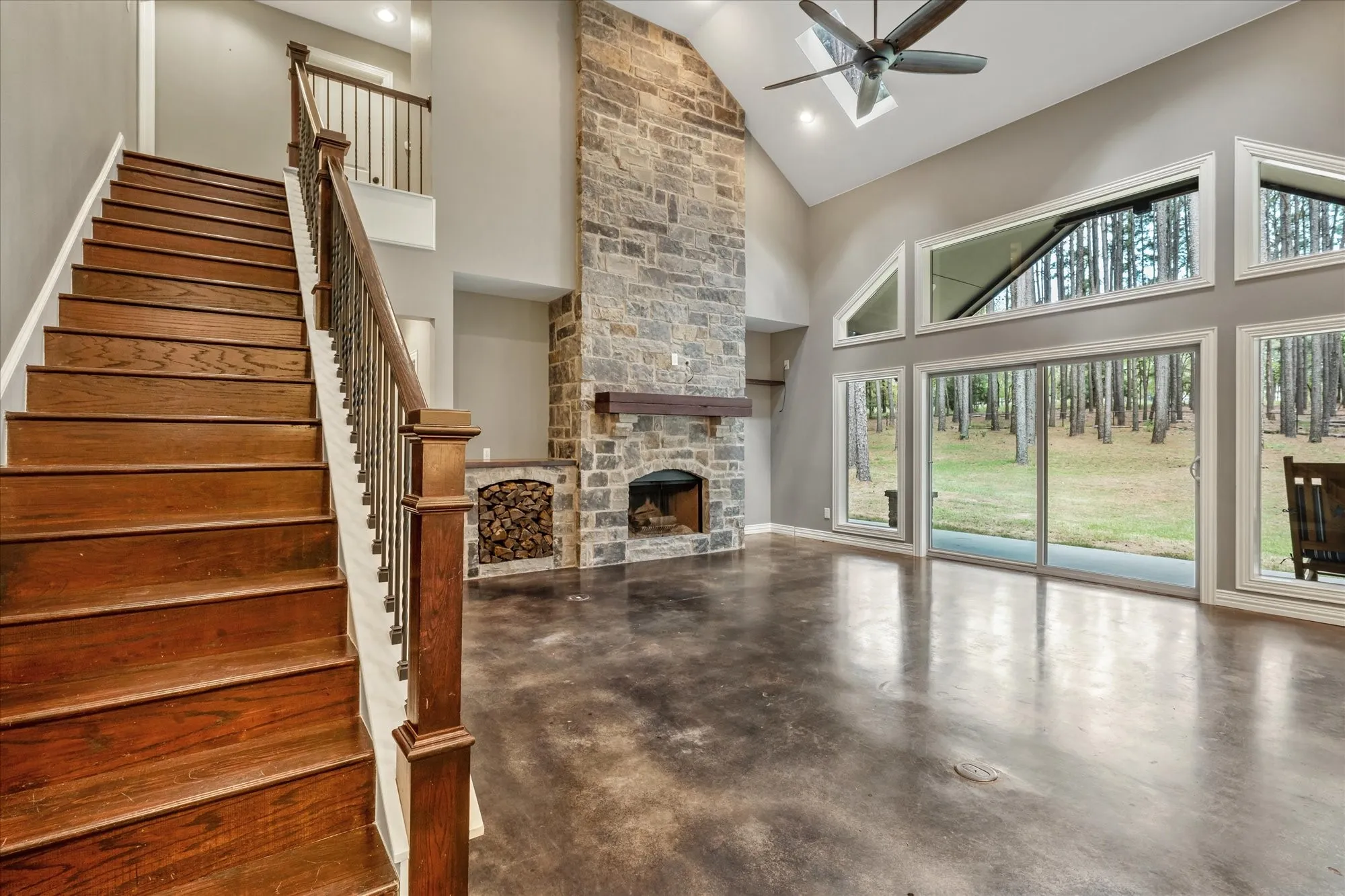 Family room with wood ready for the fireplace.